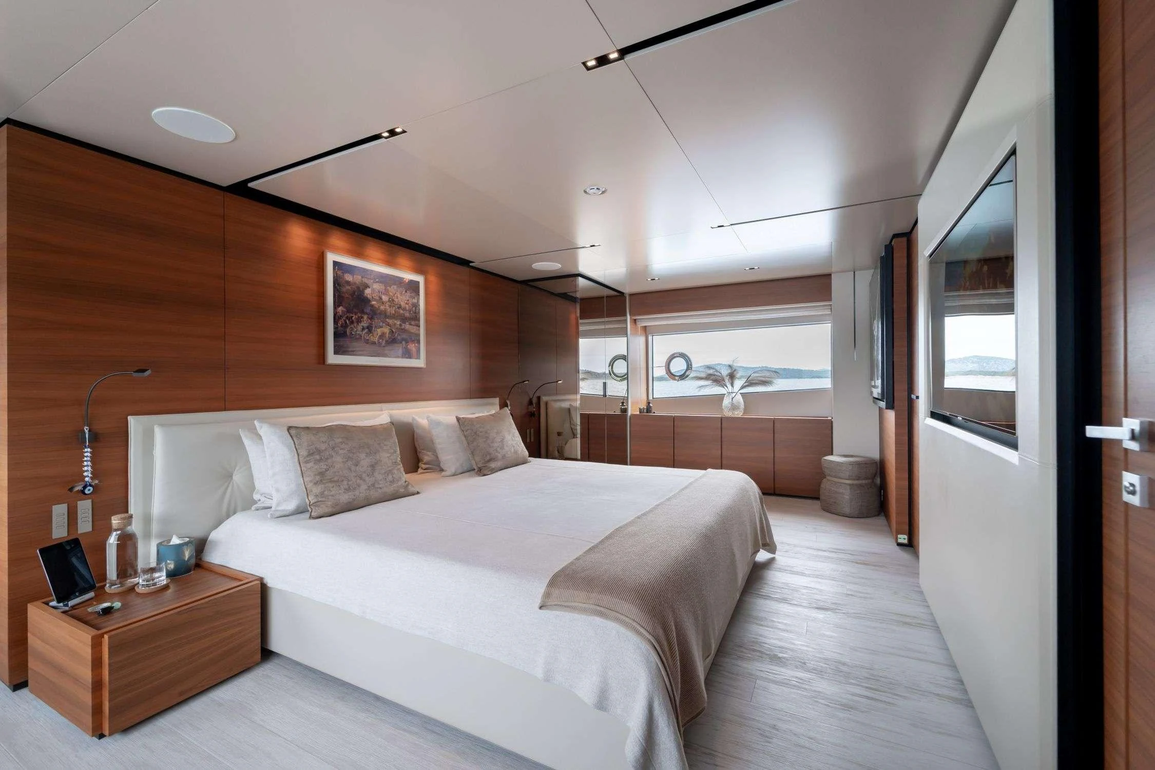 a bedroom with a bed and a desk aboard SK Yacht for Charter