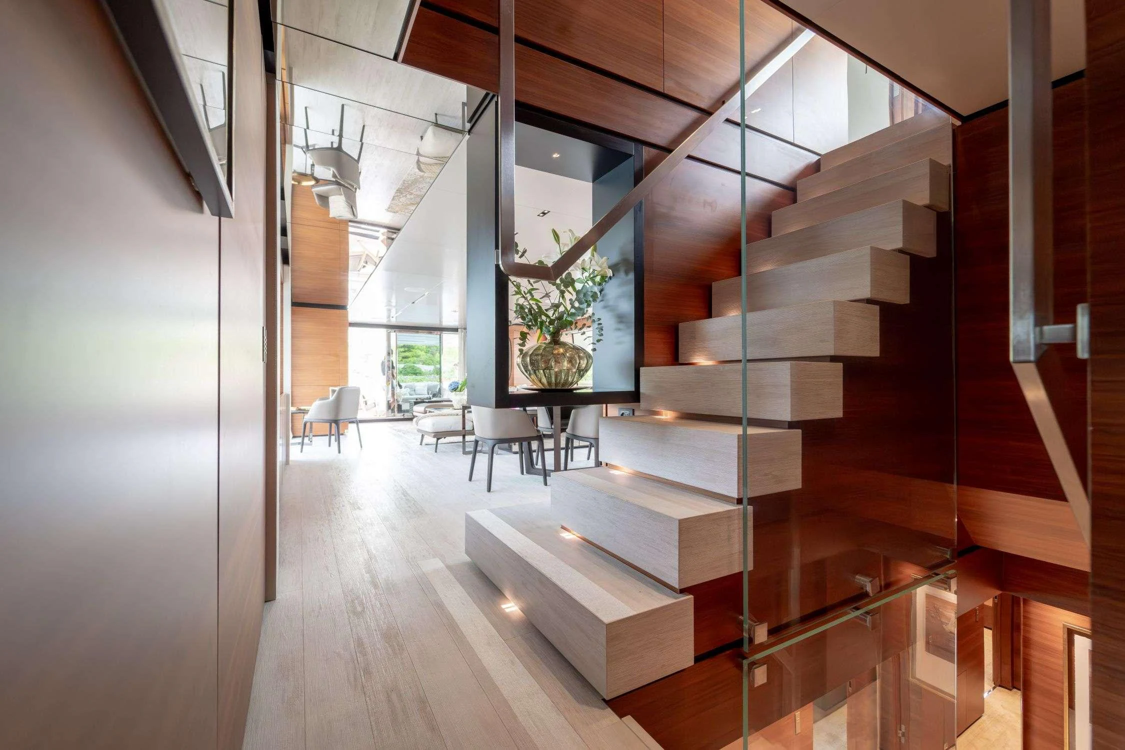 a staircase with a glass window aboard SK Yacht for Charter