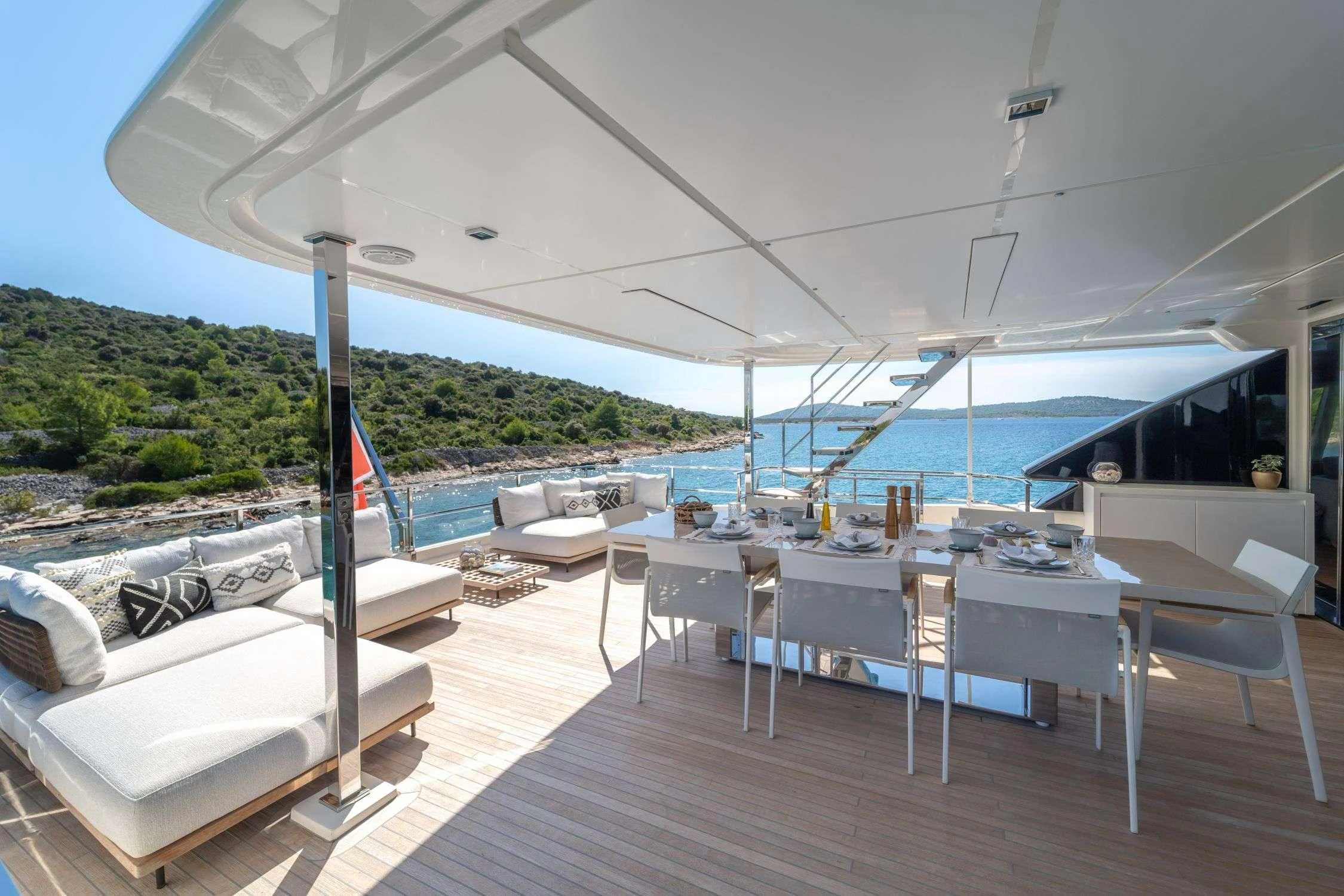 a deck with a view of the water and the land aboard SK Yacht for Charter