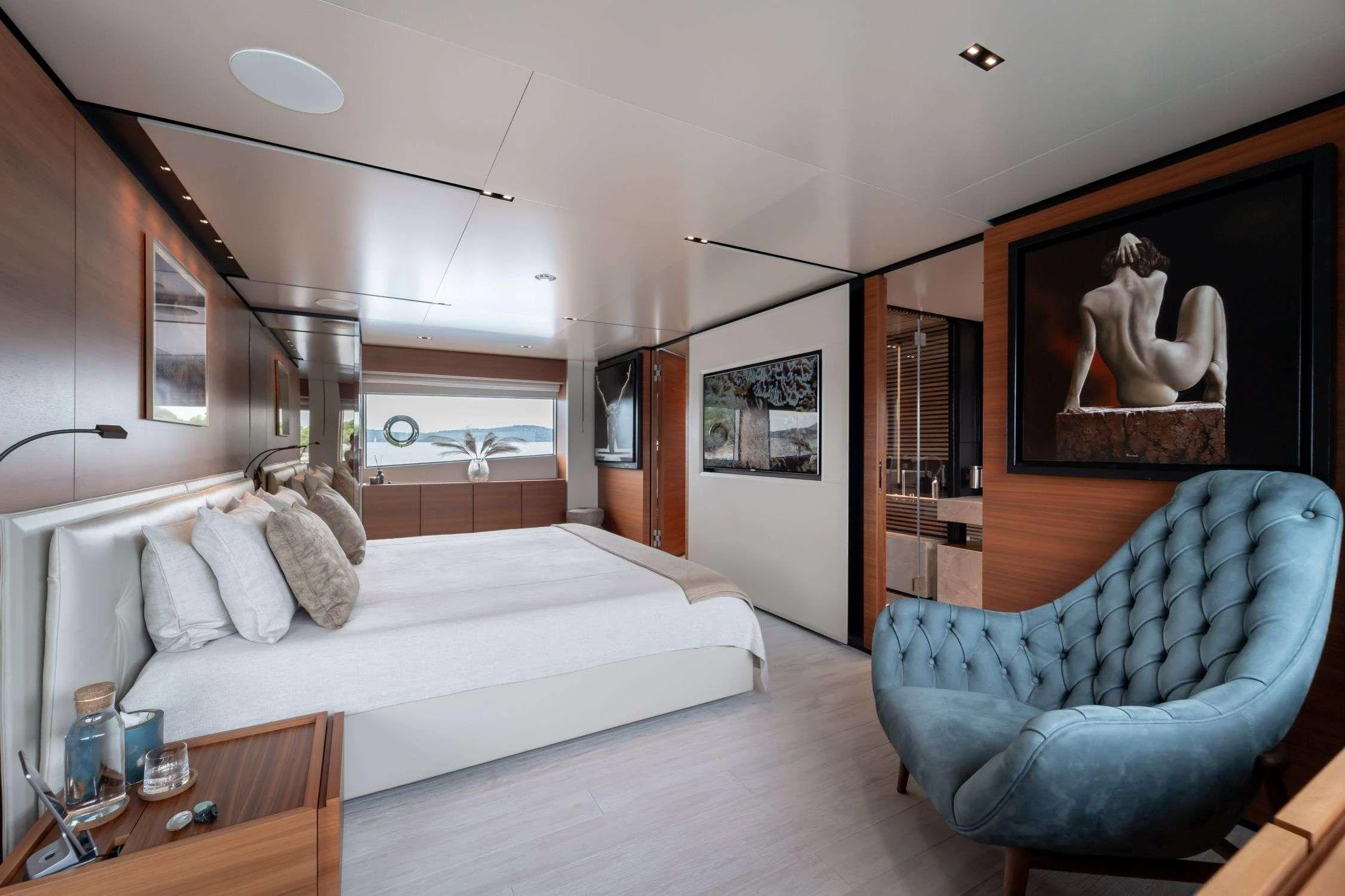 a bedroom with a blue couch aboard SK Yacht for Charter