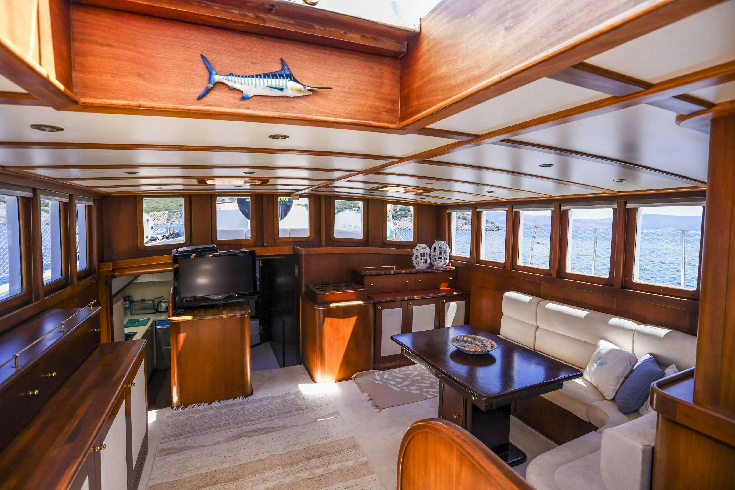 a living room with a couch and a piano aboard GAZELLA Yacht for Charter