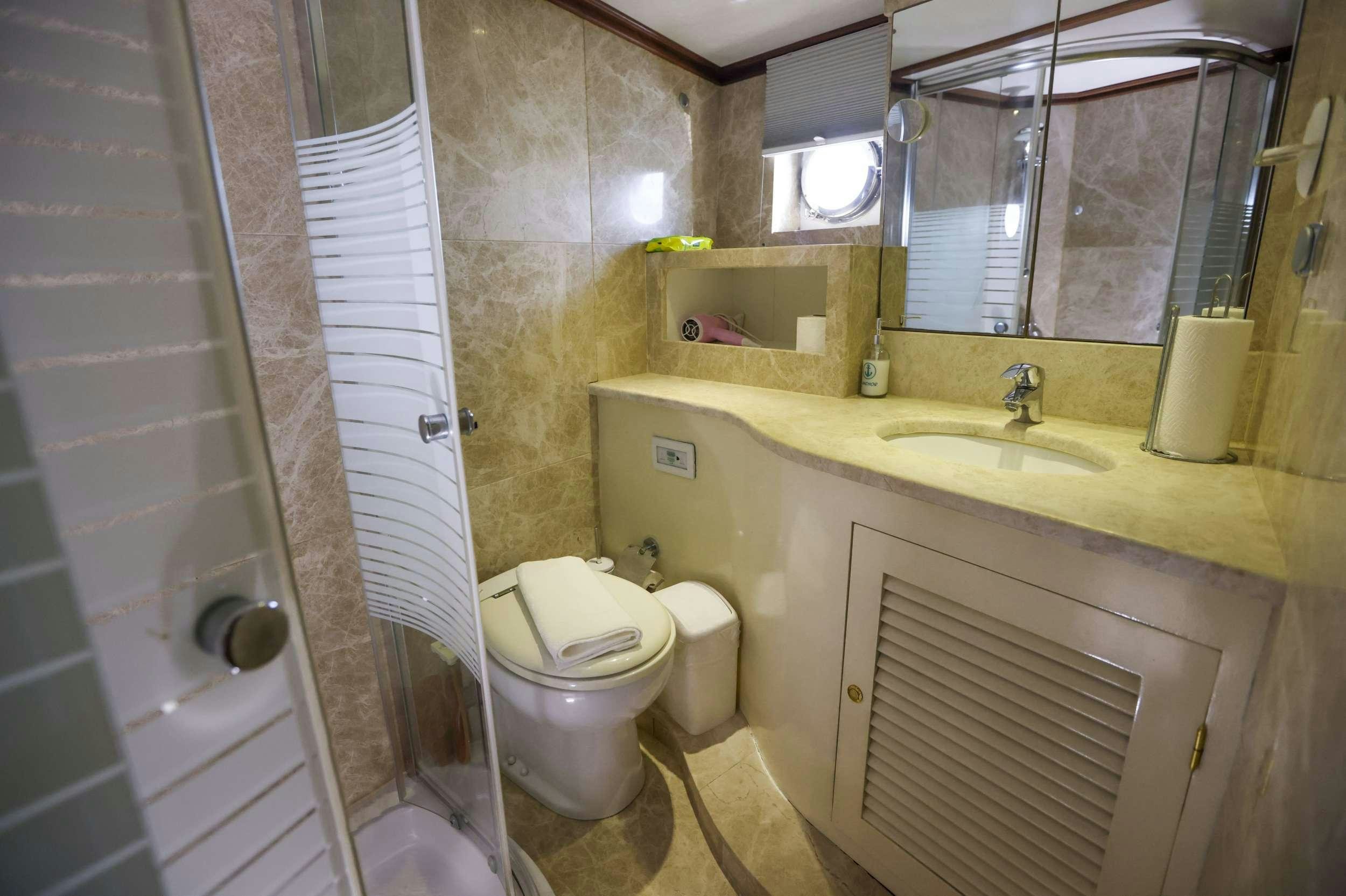 a bathroom with a toilet and sink aboard GAZELLA Yacht for Charter