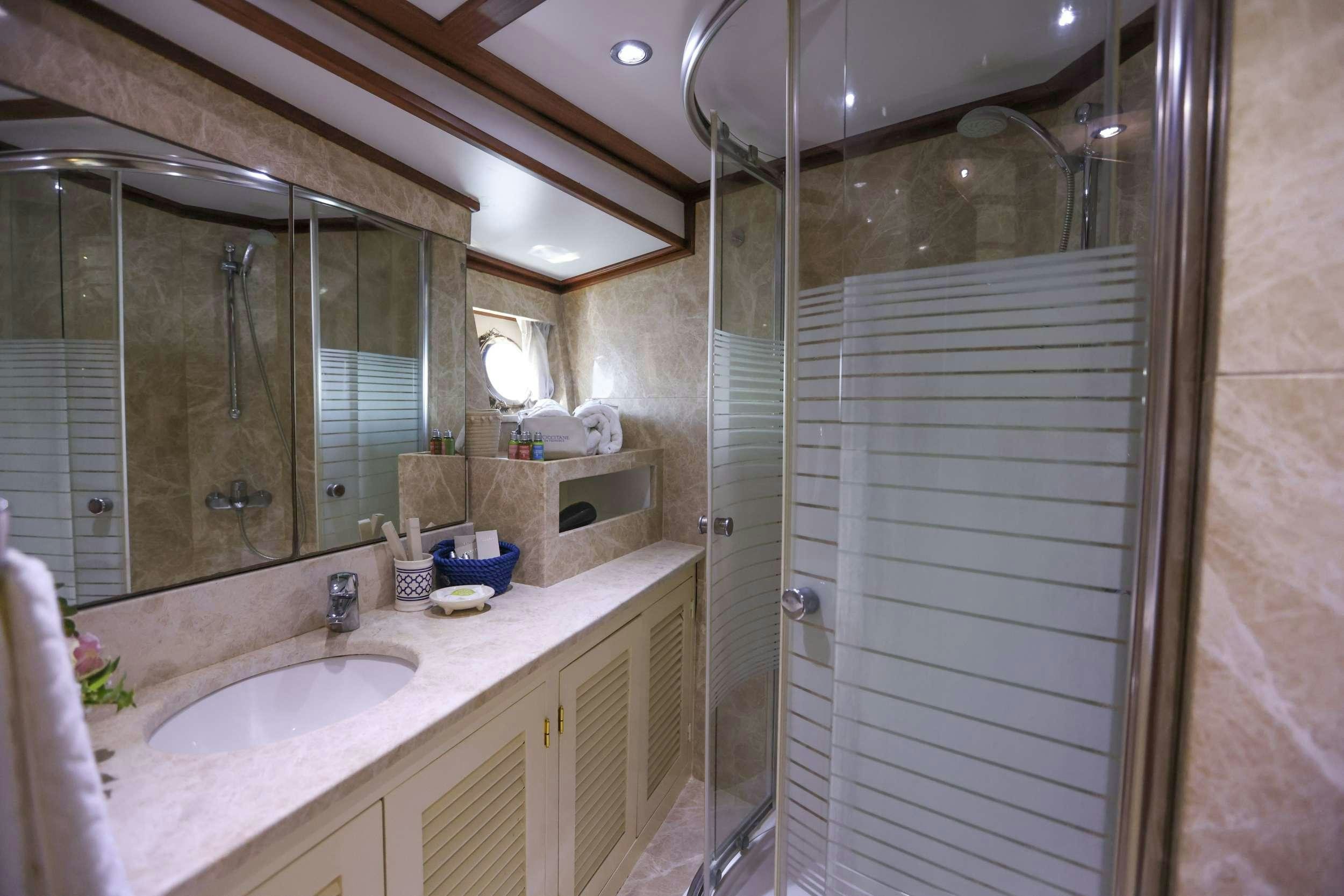 a bathroom with a shower unit and sink aboard GAZELLA Yacht for Charter