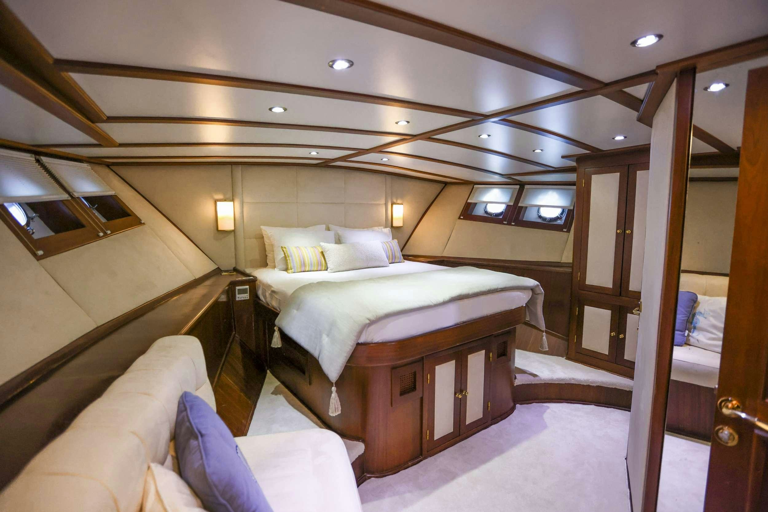 a room with a bed and a mirror aboard GAZELLA Yacht for Charter