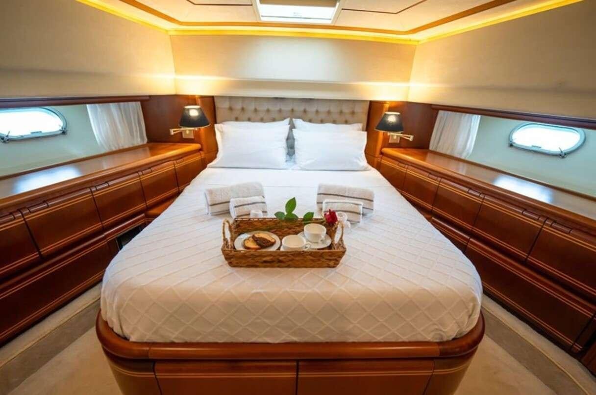 a bed with a tray of food aboard BELLAS BOY Yacht for Charter