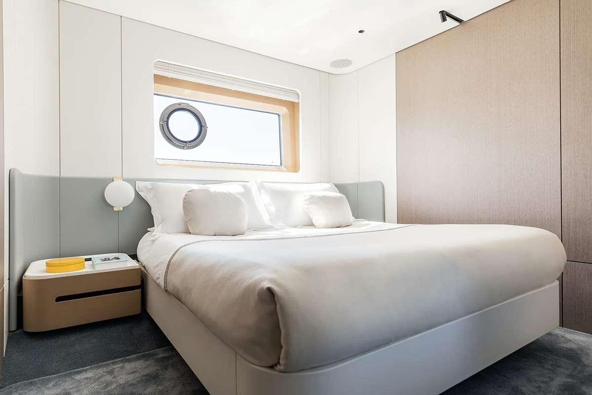 a bed with white sheets aboard ALADDIN SANE Yacht for Charter