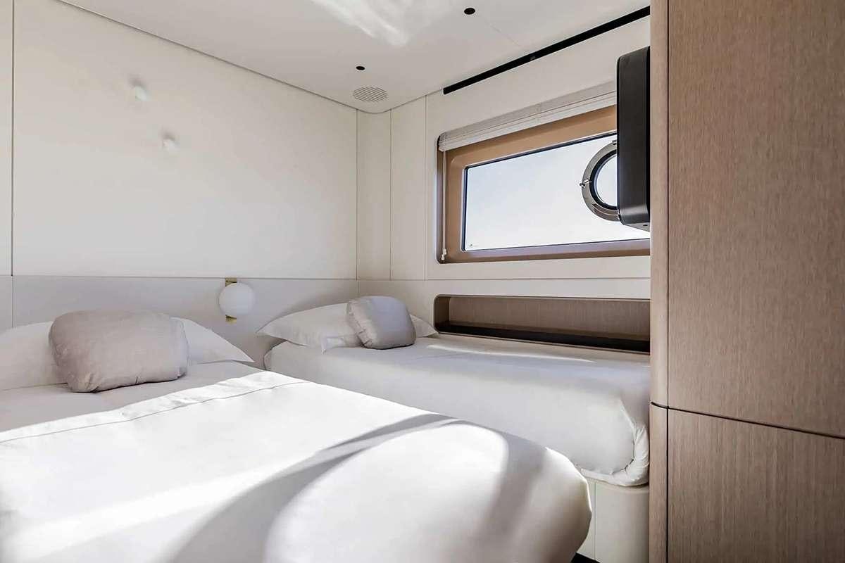 a couple of beds in a room aboard ALADDIN SANE Yacht for Charter