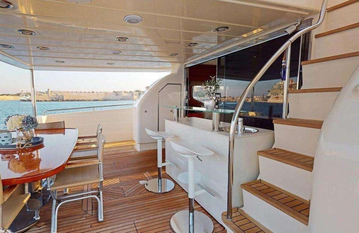 a room with a bed and a table aboard STRESS NEGATIVE Yacht for Charter
