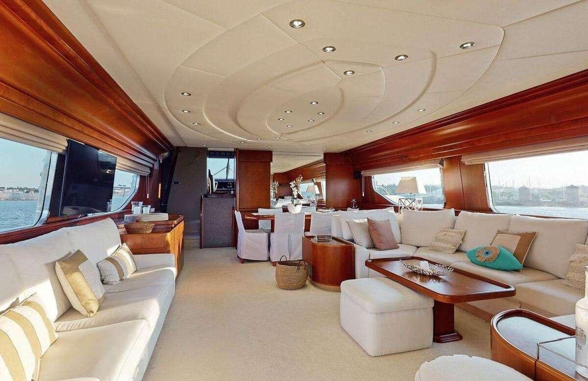 a living room with a couch and a table aboard STRESS NEGATIVE Yacht for Charter