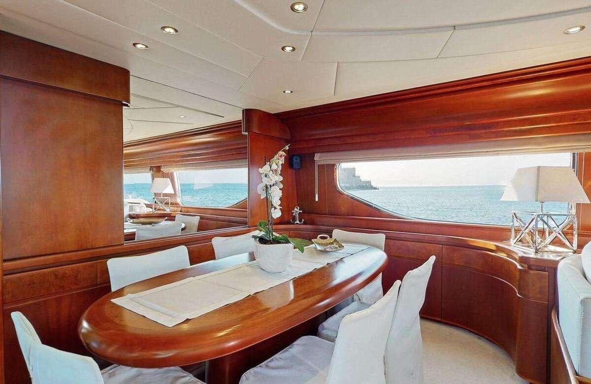 a room with a table and chairs aboard STRESS NEGATIVE Yacht for Charter