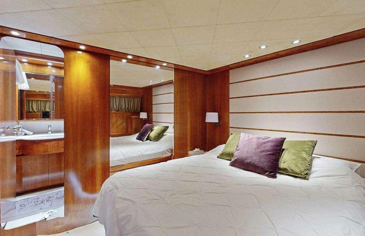 a room with a bed and a sink aboard STRESS NEGATIVE Yacht for Charter