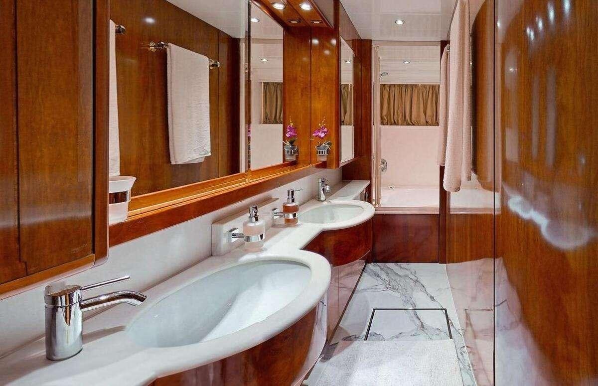 a bathroom with two sinks and a large mirror aboard STRESS NEGATIVE Yacht for Charter