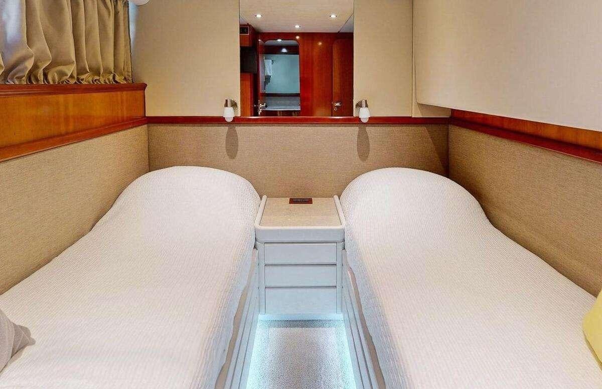 a room with two beds aboard STRESS NEGATIVE Yacht for Charter