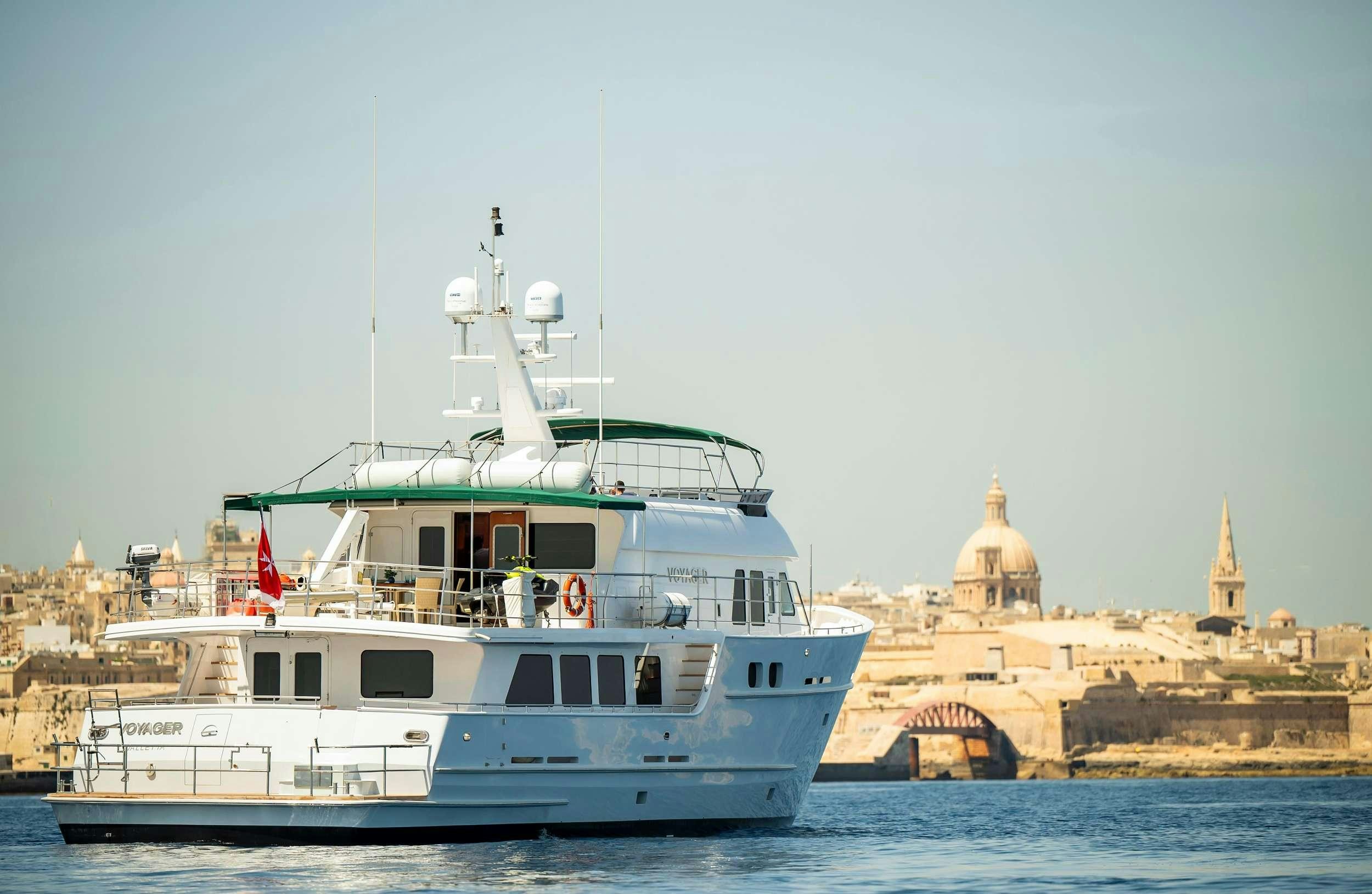 a large white boat in the water aboard VOYAGER Yacht for Charter