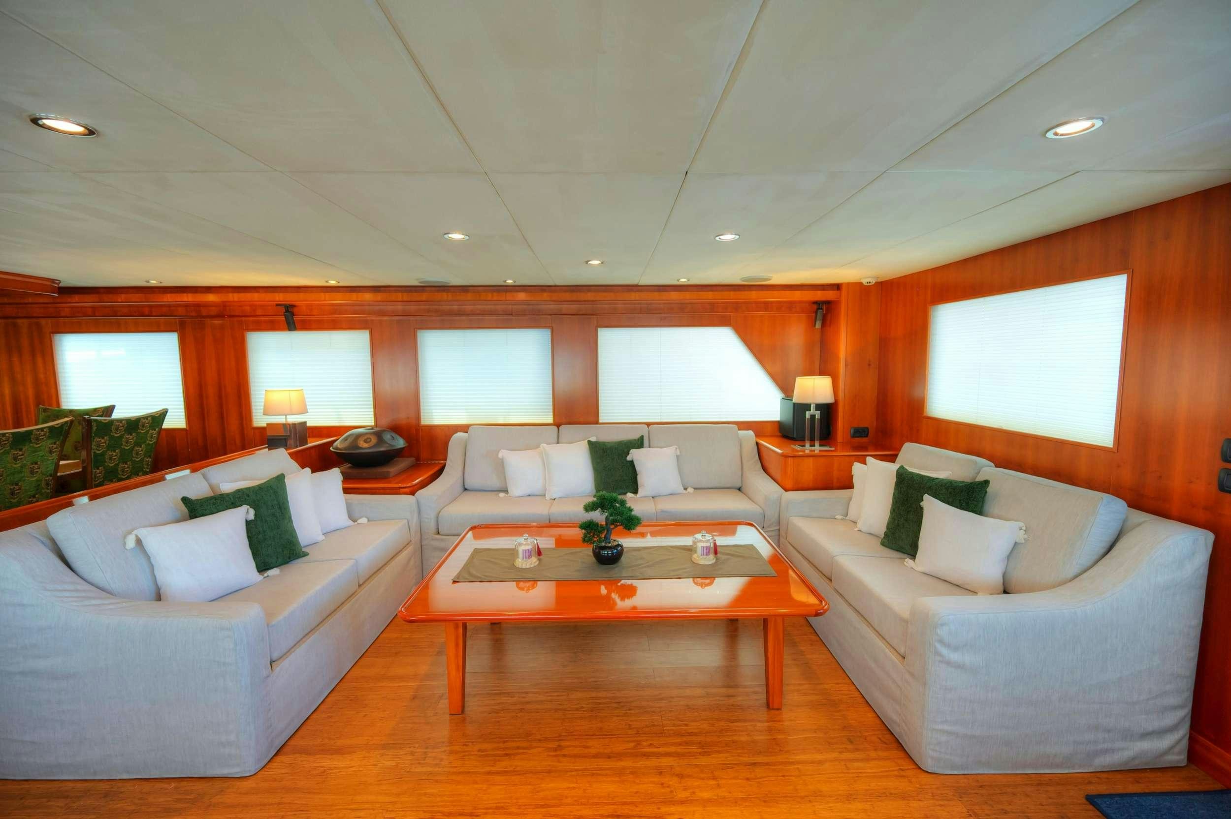 a living room with a couch and a coffee table aboard VOYAGER Yacht for Charter