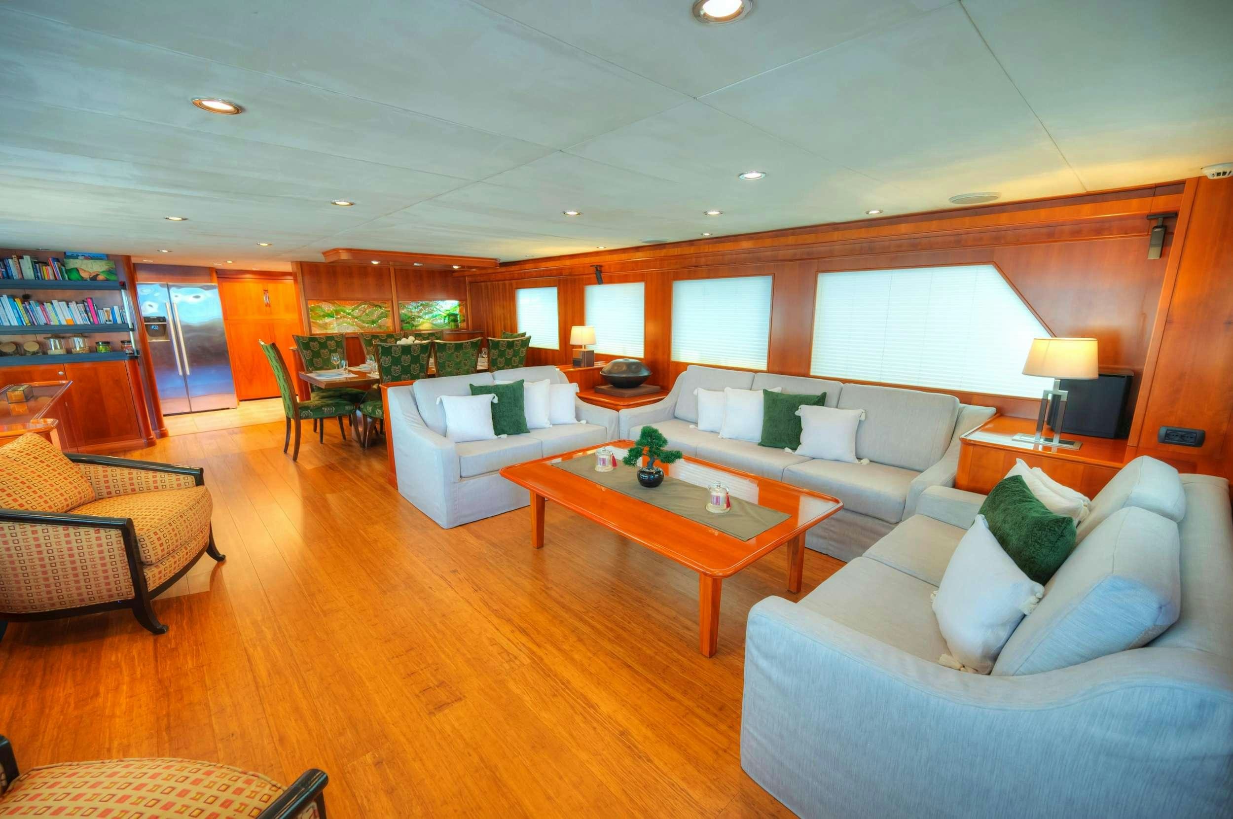 a living room with a table and couches aboard VOYAGER Yacht for Charter