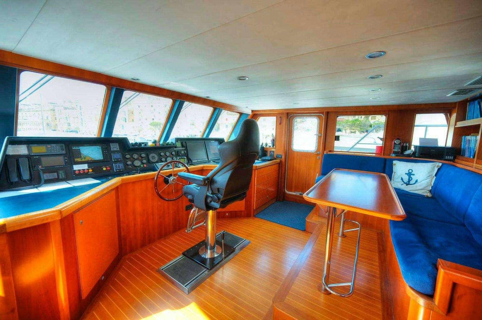 a room with a piano and a chair aboard VOYAGER Yacht for Charter