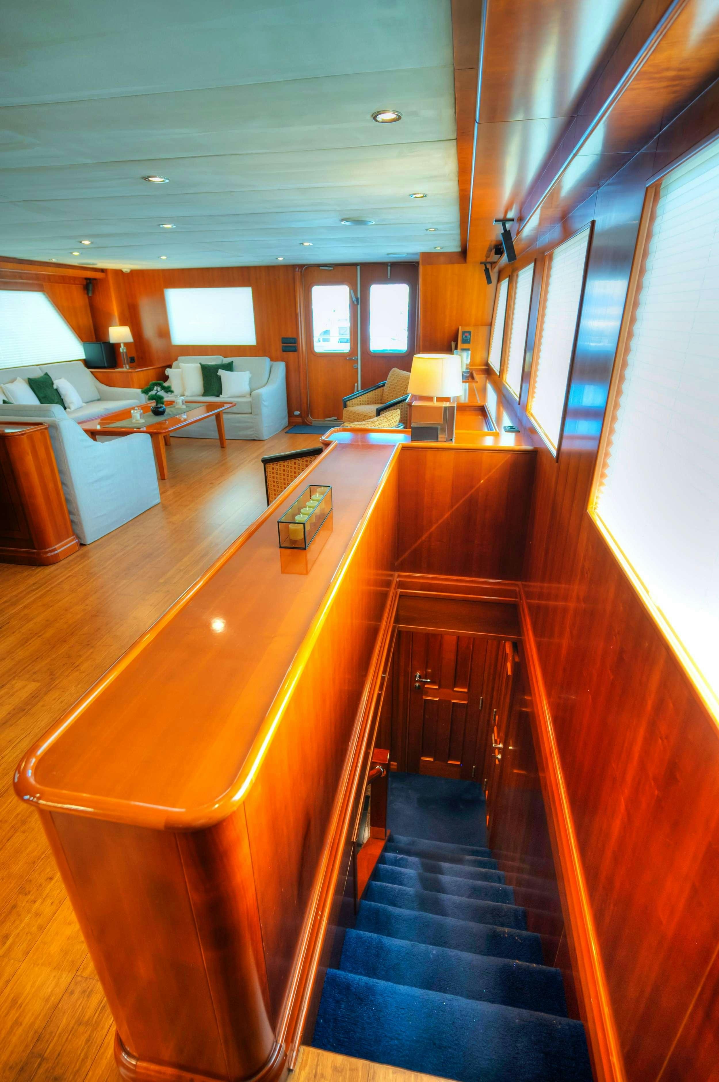 a long hallway with a desk and a couch aboard VOYAGER Yacht for Charter