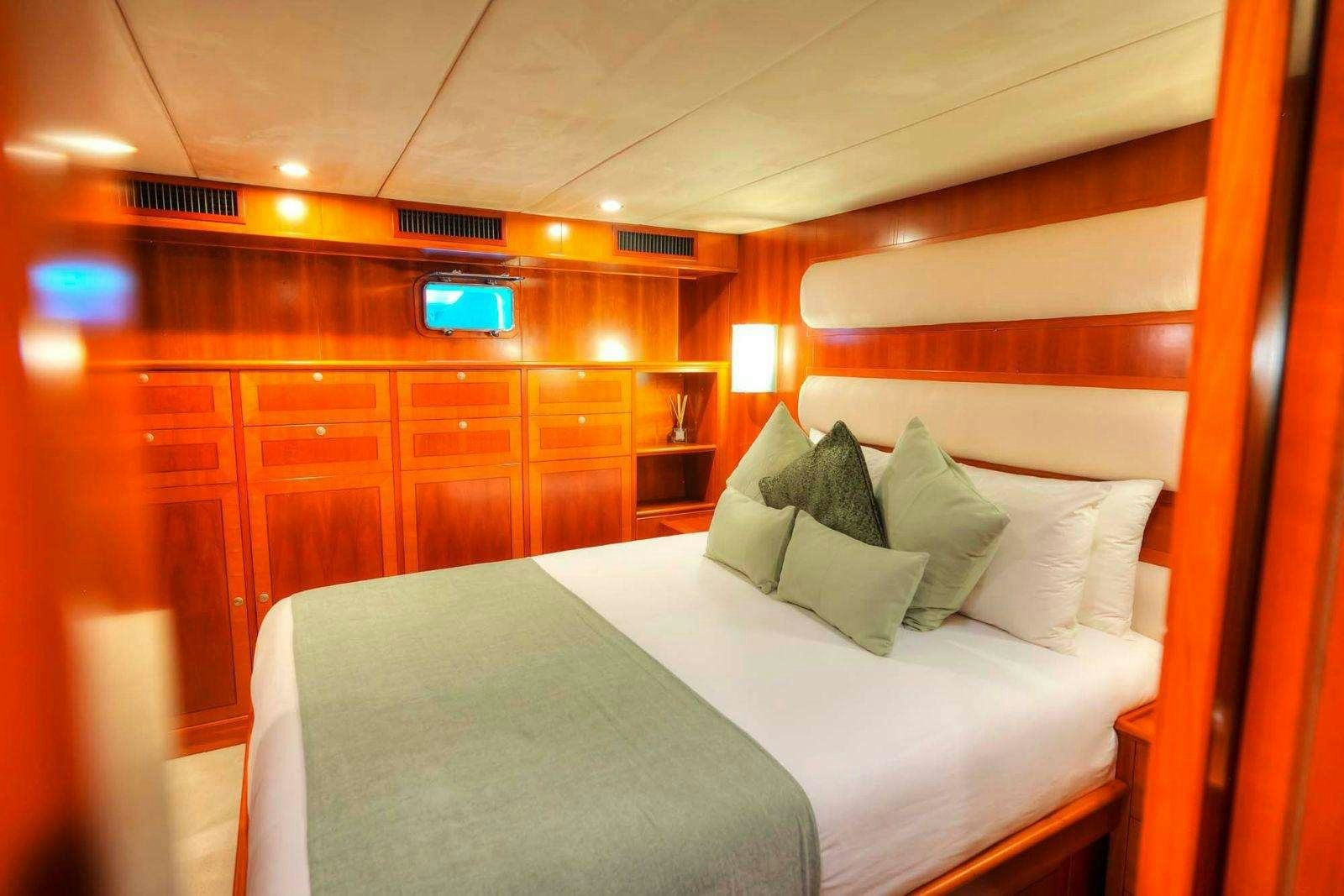a bed with pillows and pillows aboard VOYAGER Yacht for Charter