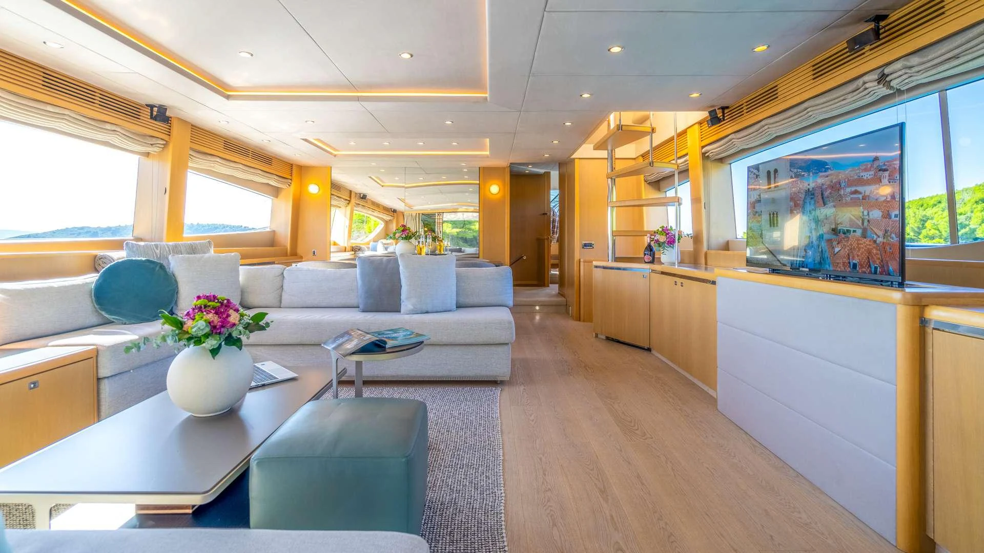 a living room with a large window aboard INSIEME Yacht for Charter