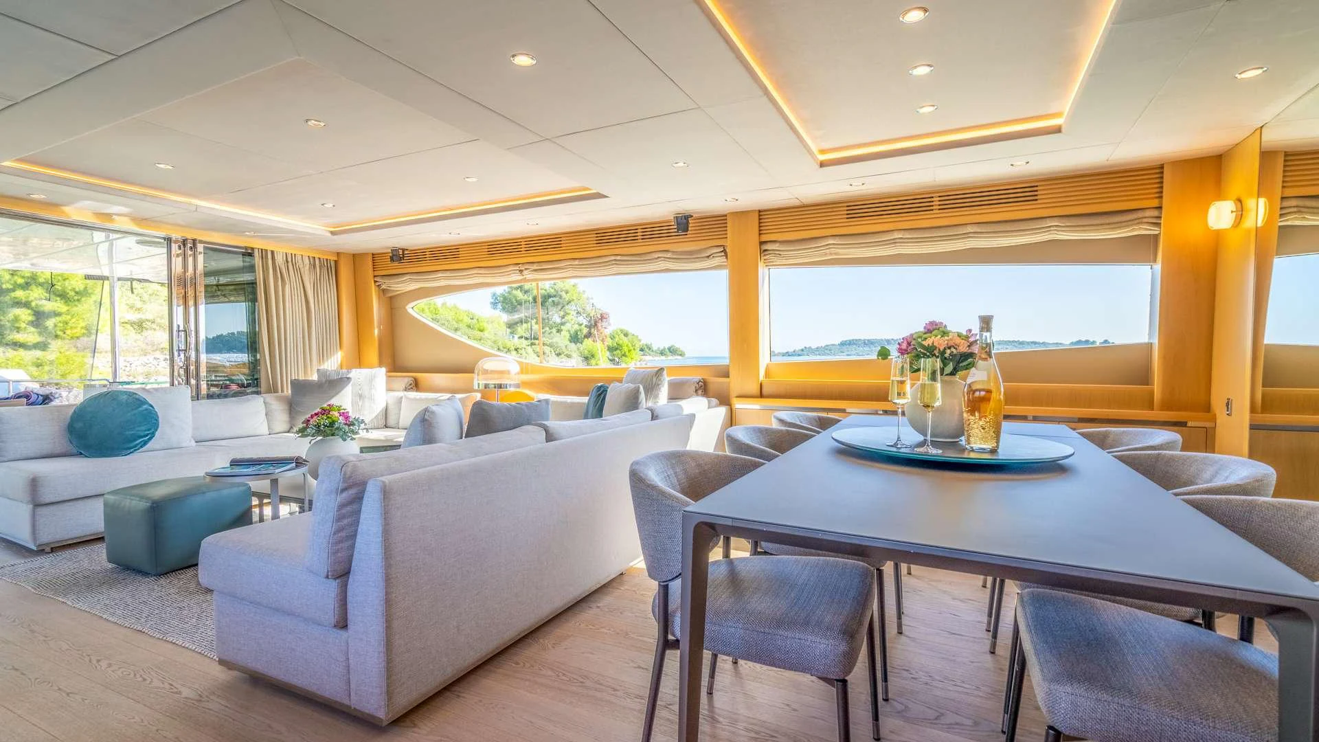 a living room with a table and couches aboard INSIEME Yacht for Charter