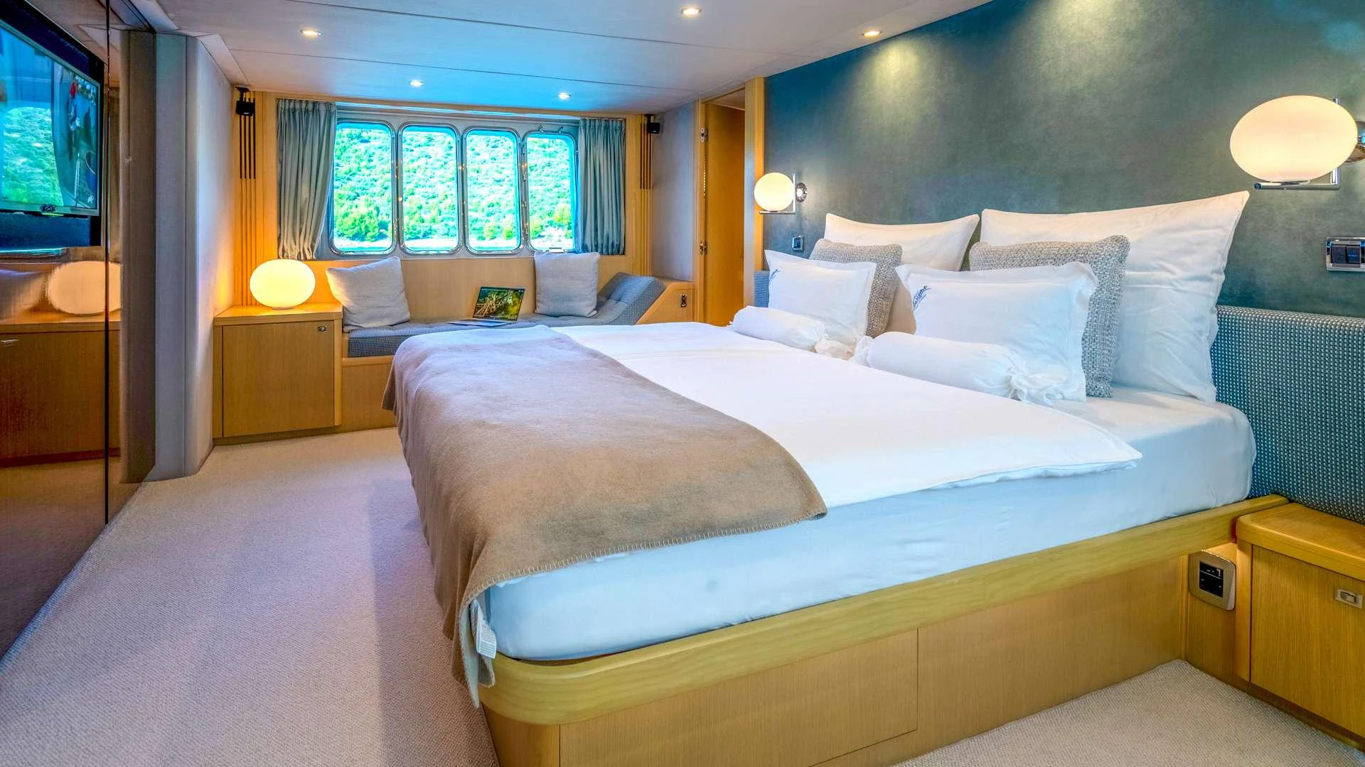 a room with a bed and a couch aboard INSIEME Yacht for Charter