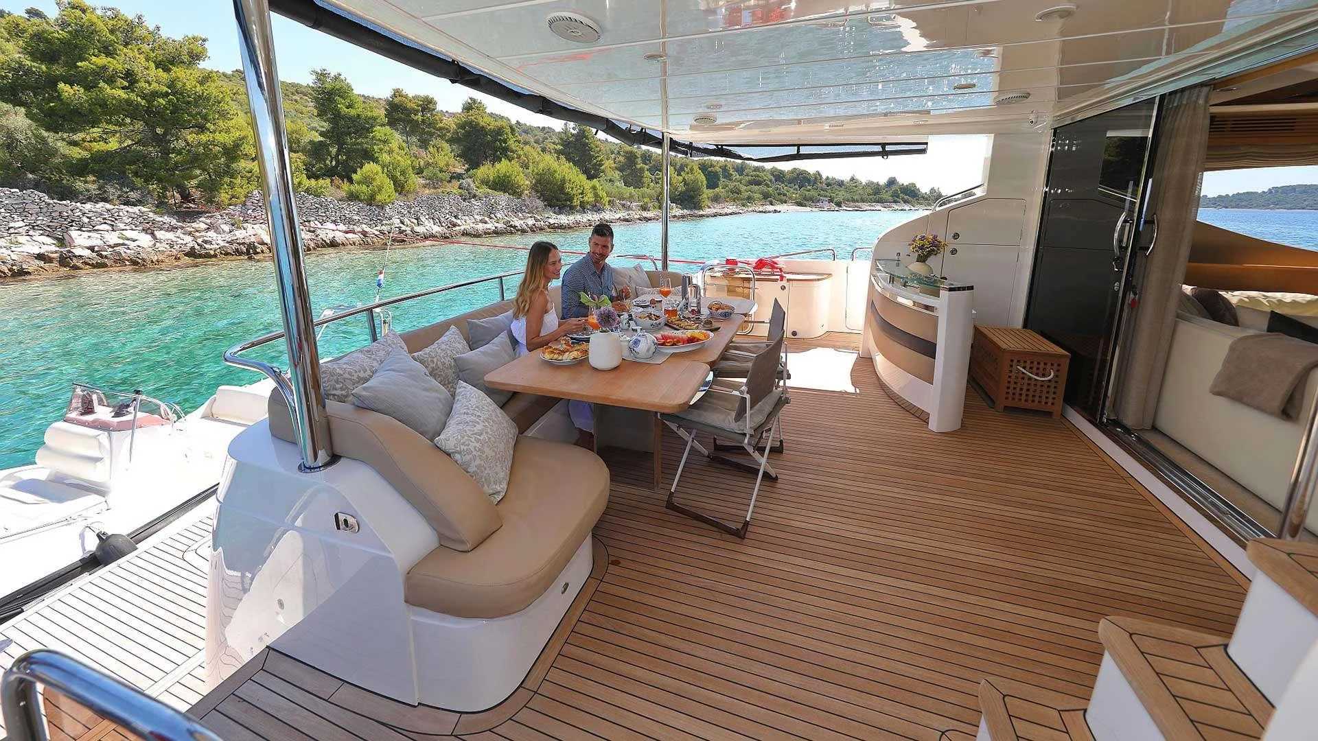 a couple sitting at a table on a boat aboard INSIEME Yacht for Charter