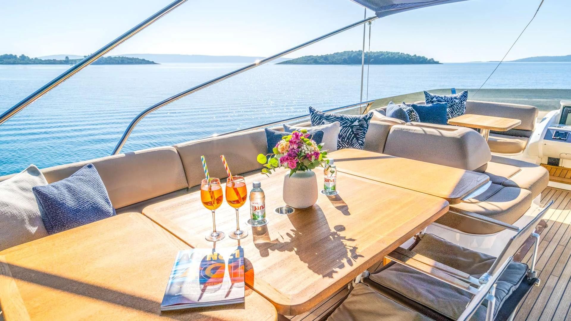 a table with glasses and a vase with flowers on it aboard INSIEME Yacht for Charter