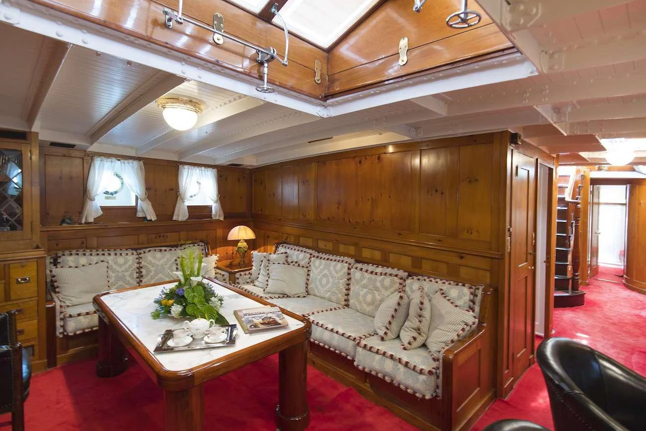 a living room with a couch and a table aboard PURITAN Yacht for Charter