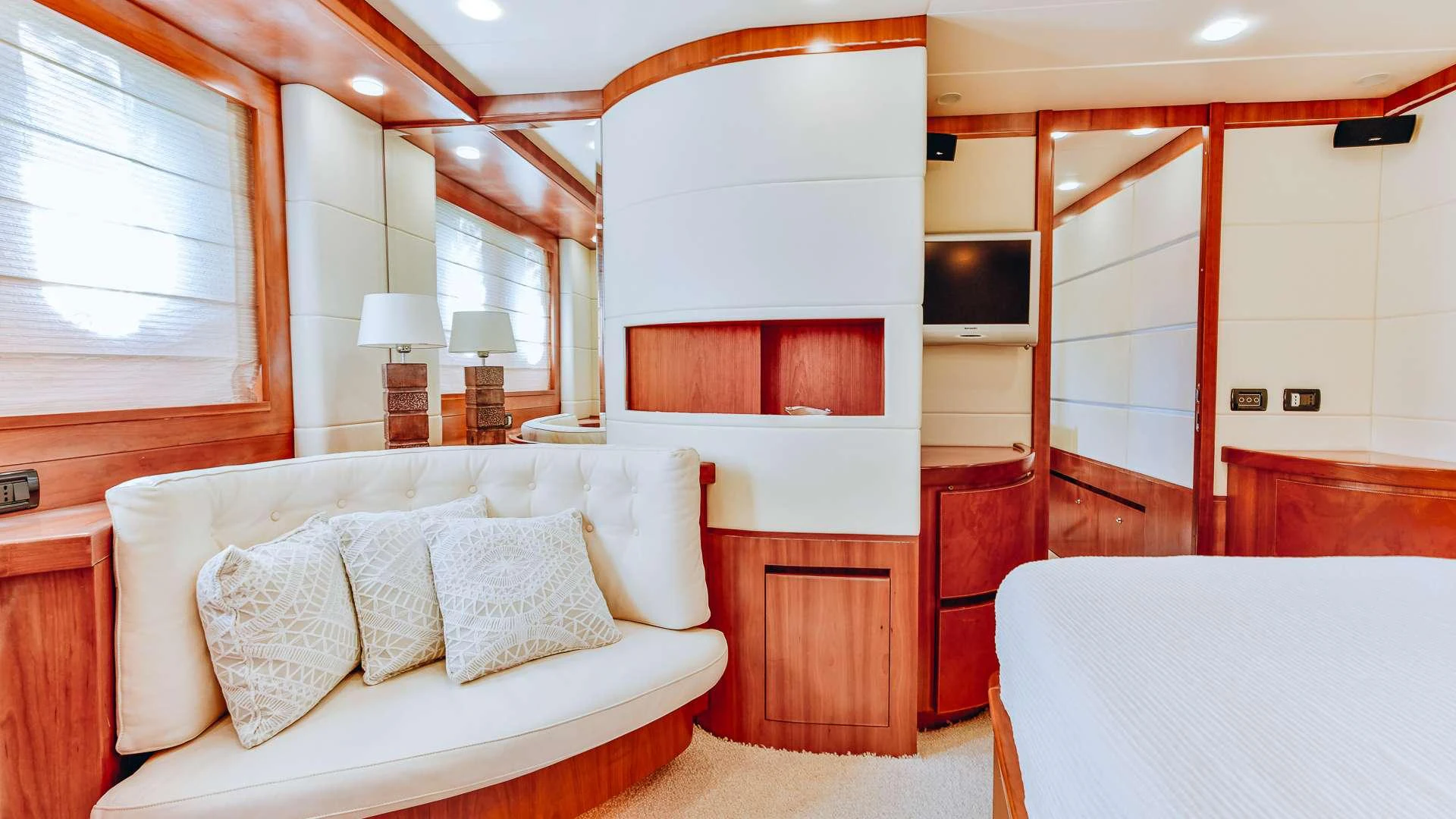 a room with a bed and a television aboard CAMY Yacht for Charter