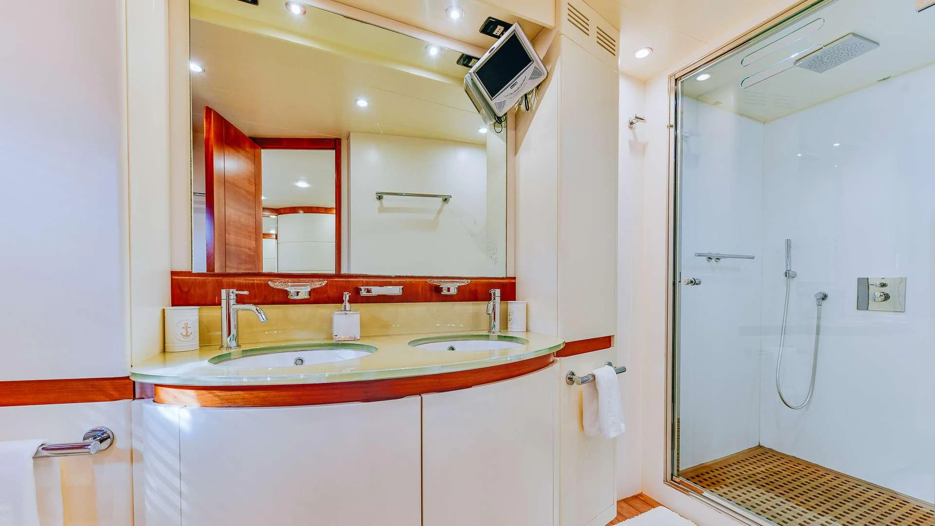 a bathroom with a sink and a mirror aboard CAMY Yacht for Charter