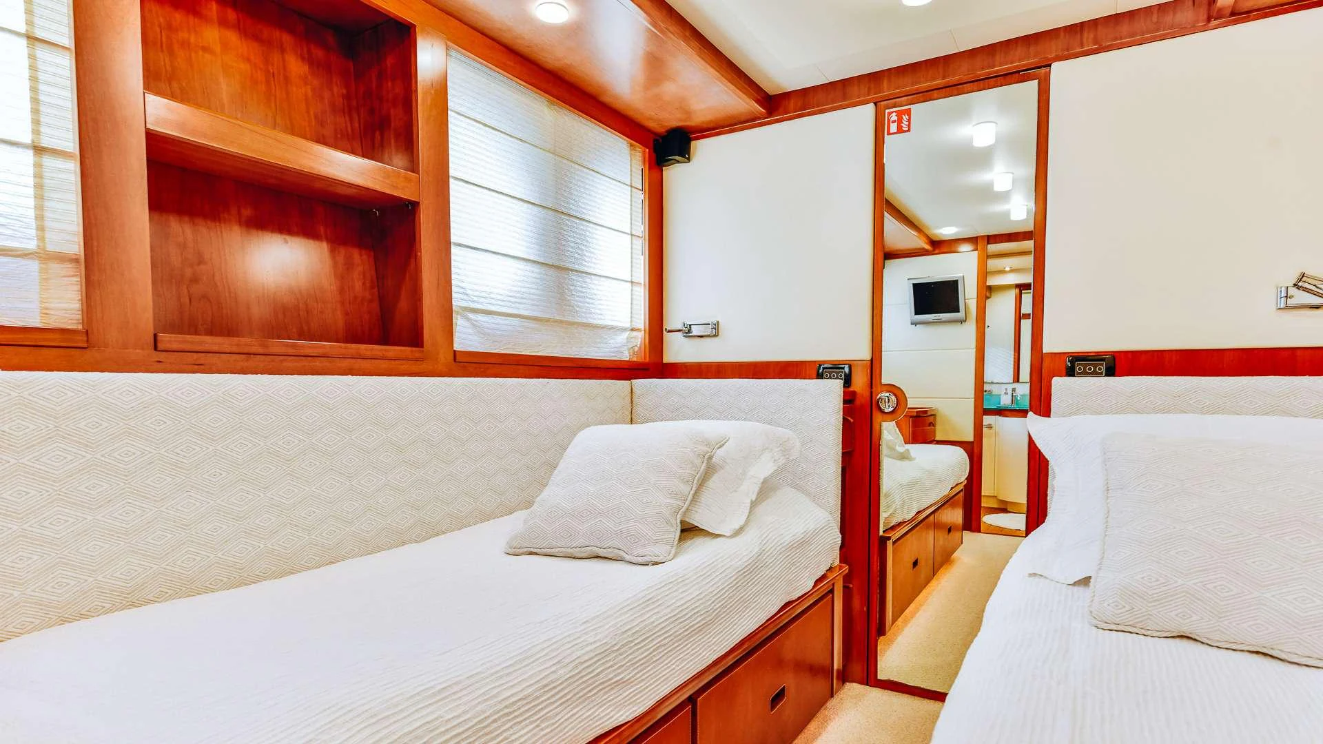 a room with a bed and a window aboard CAMY Yacht for Charter