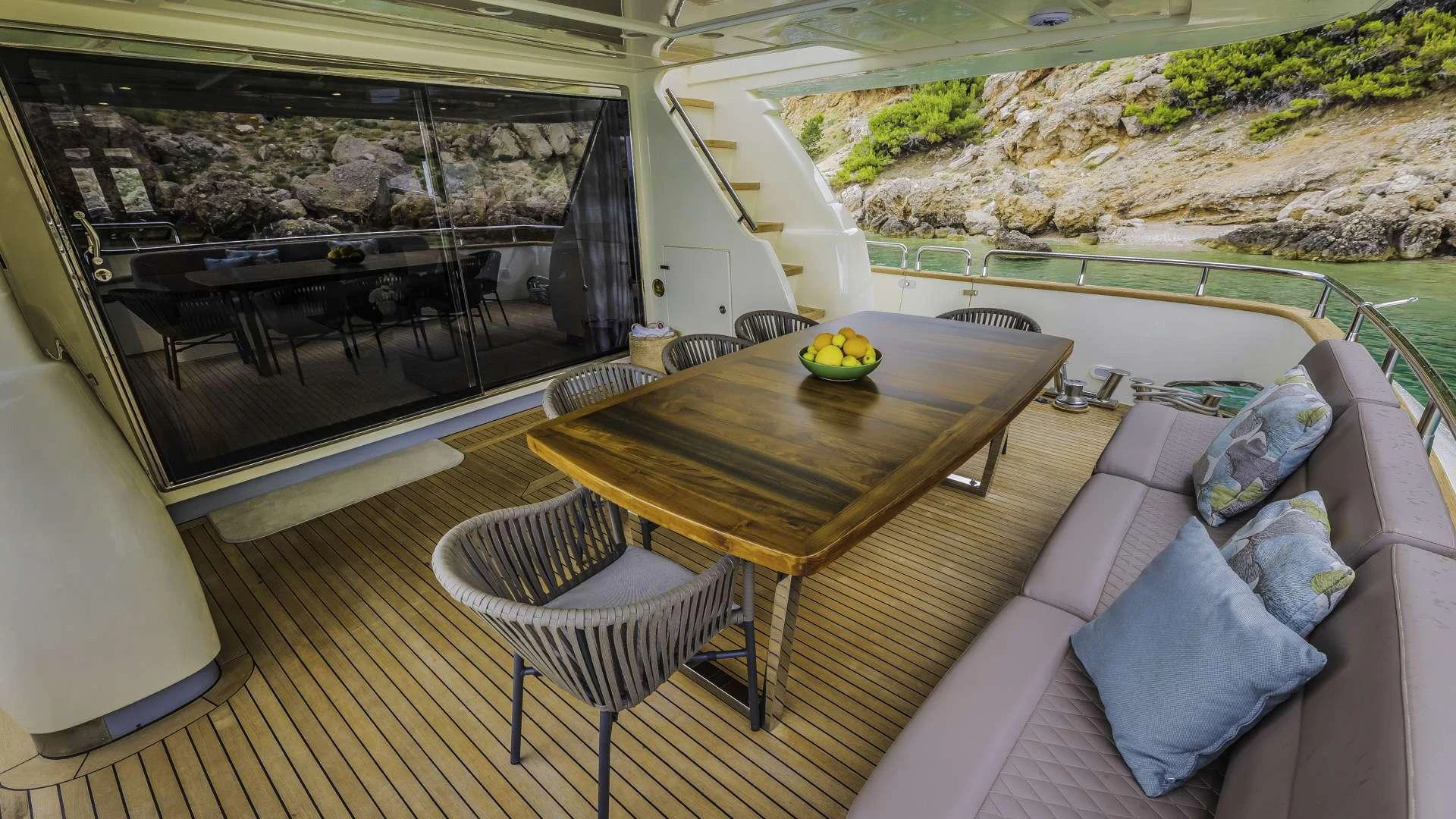 a table and chairs on a balcony aboard KARISMA Yacht for Charter