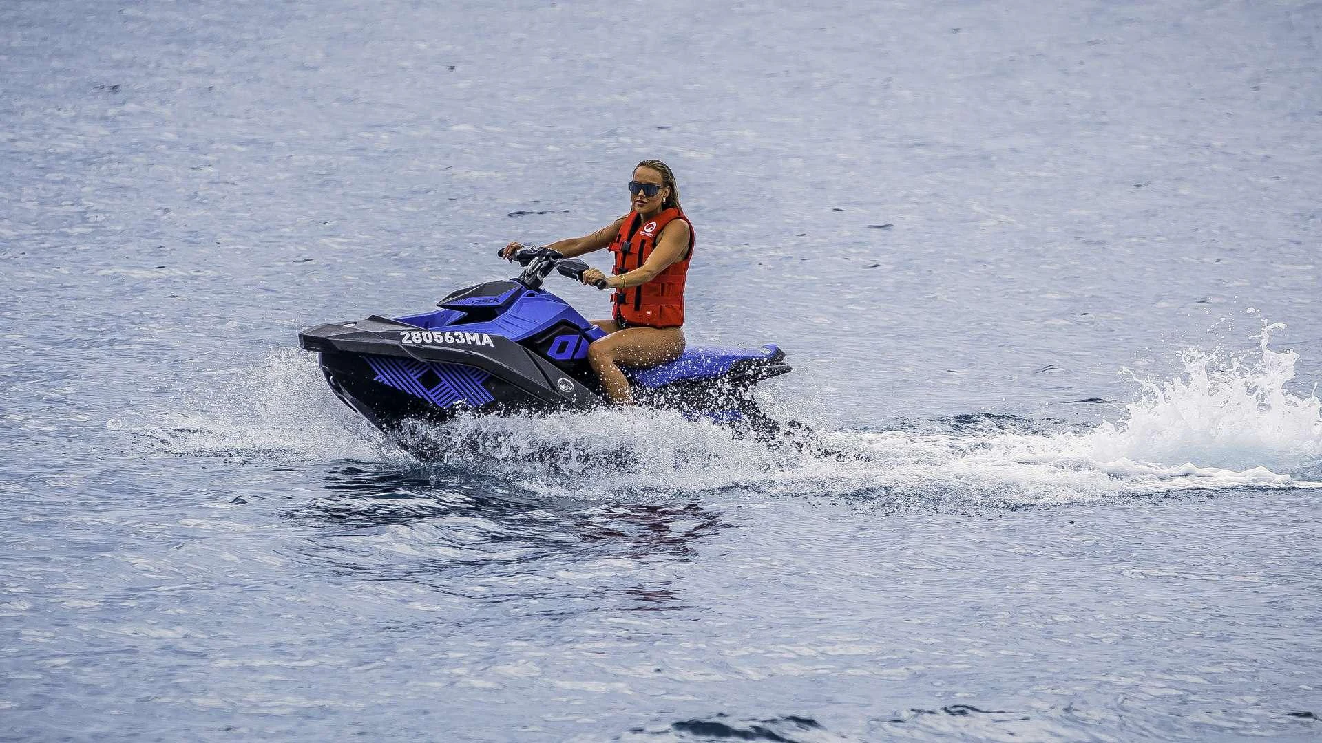 a man riding a jet ski aboard KARISMA Yacht for Charter