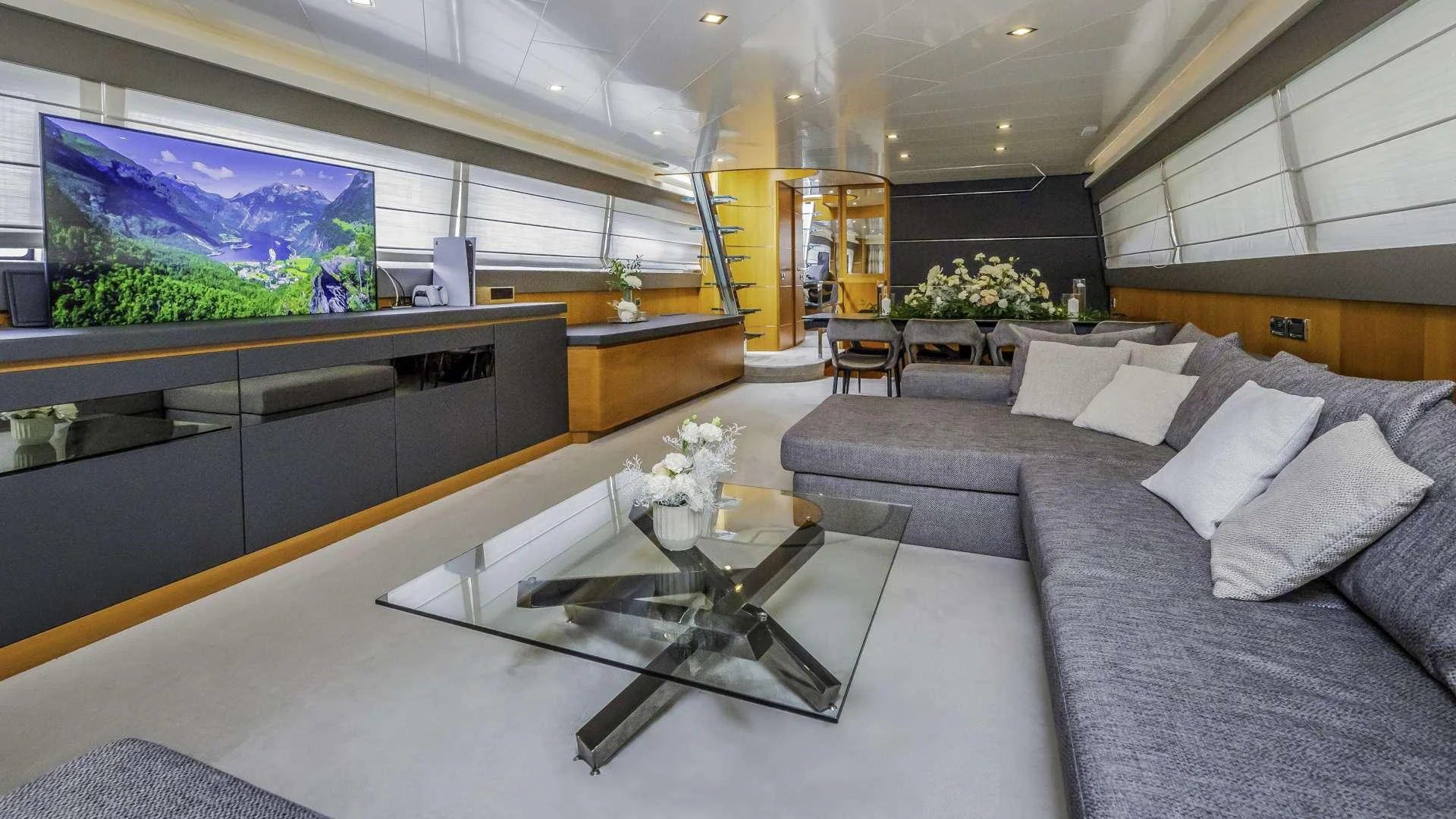 a living room with a large screen aboard KARISMA Yacht for Charter