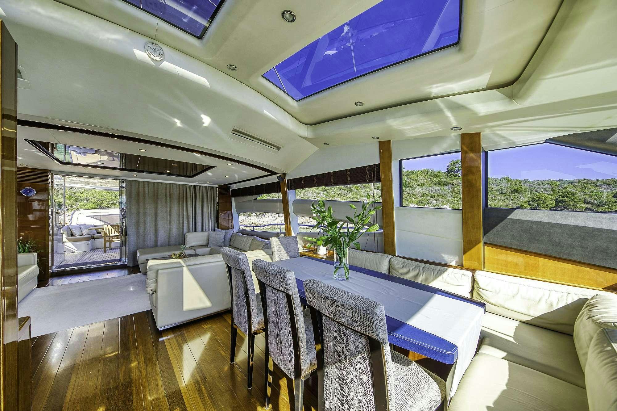 a room with a table chairs and a plant in it aboard AGAVE Yacht for Charter