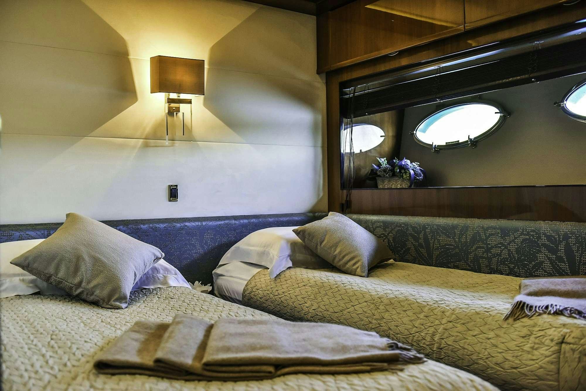 a bed with a bed and a lamp in a room aboard AGAVE Yacht for Charter
