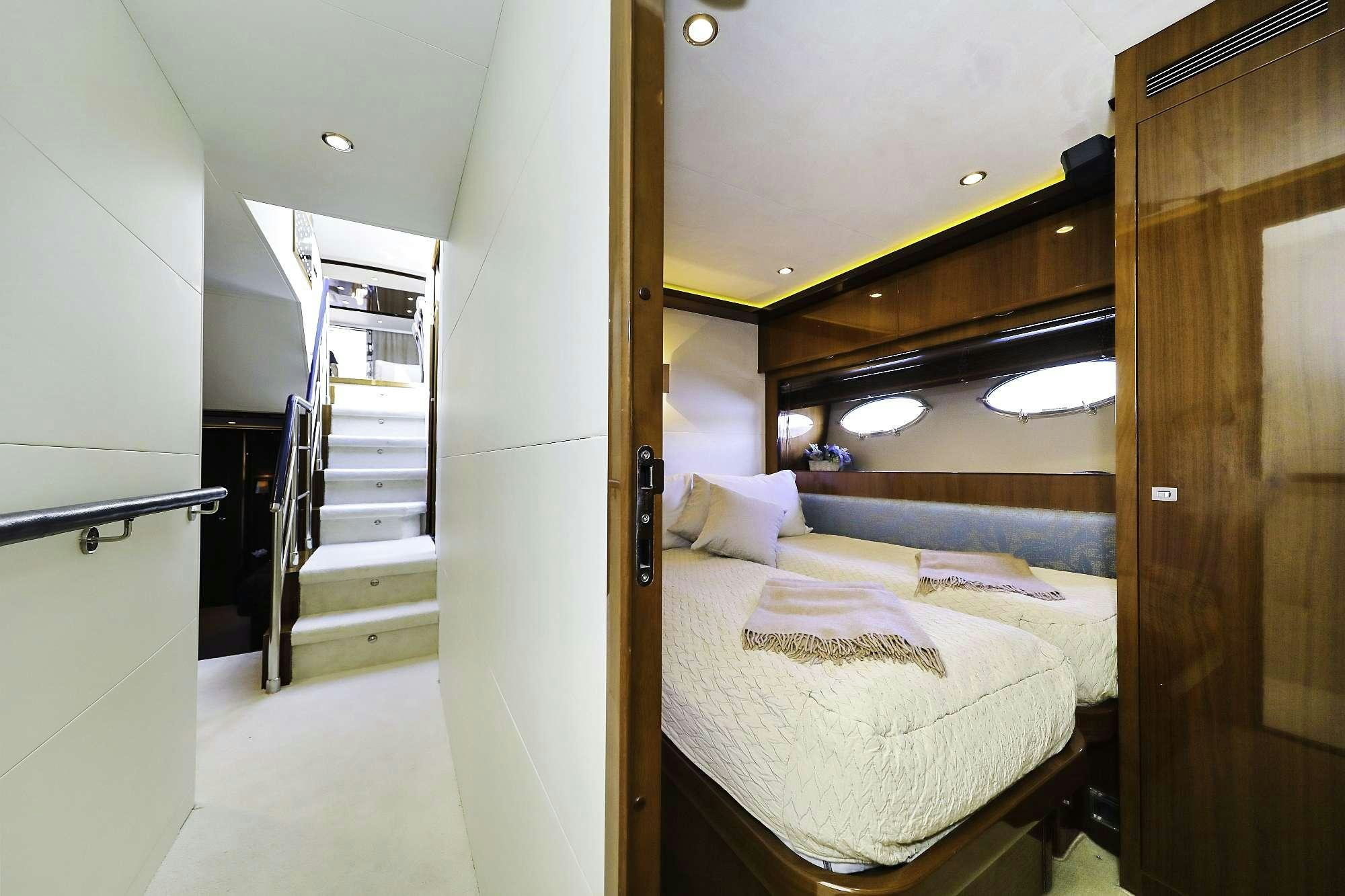 a bedroom with a bed and a staircase aboard AGAVE Yacht for Charter