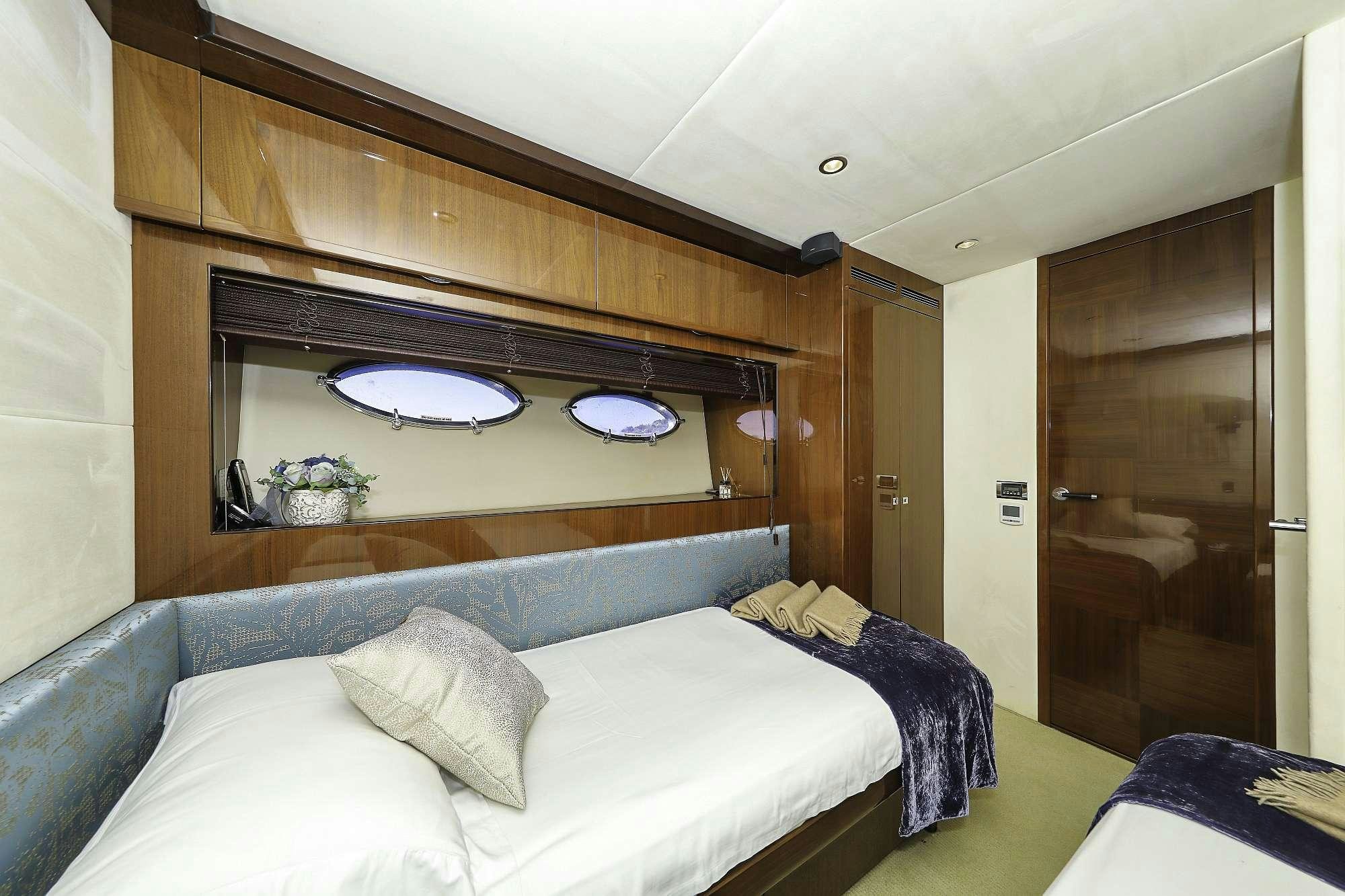 a bed with a blue blanket aboard AGAVE Yacht for Charter