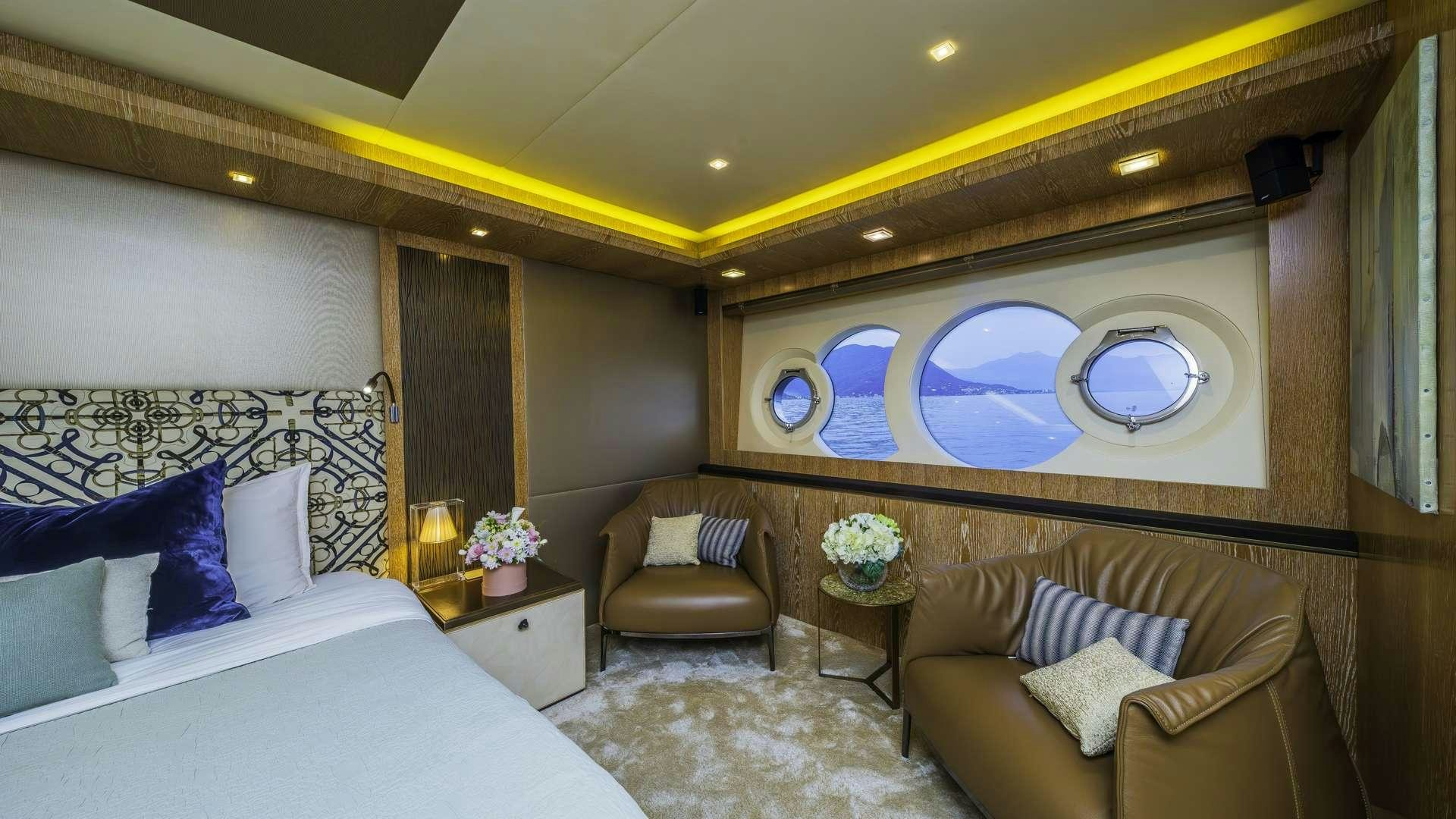 a room with a bed and a chair aboard GIORGIO Yacht for Charter