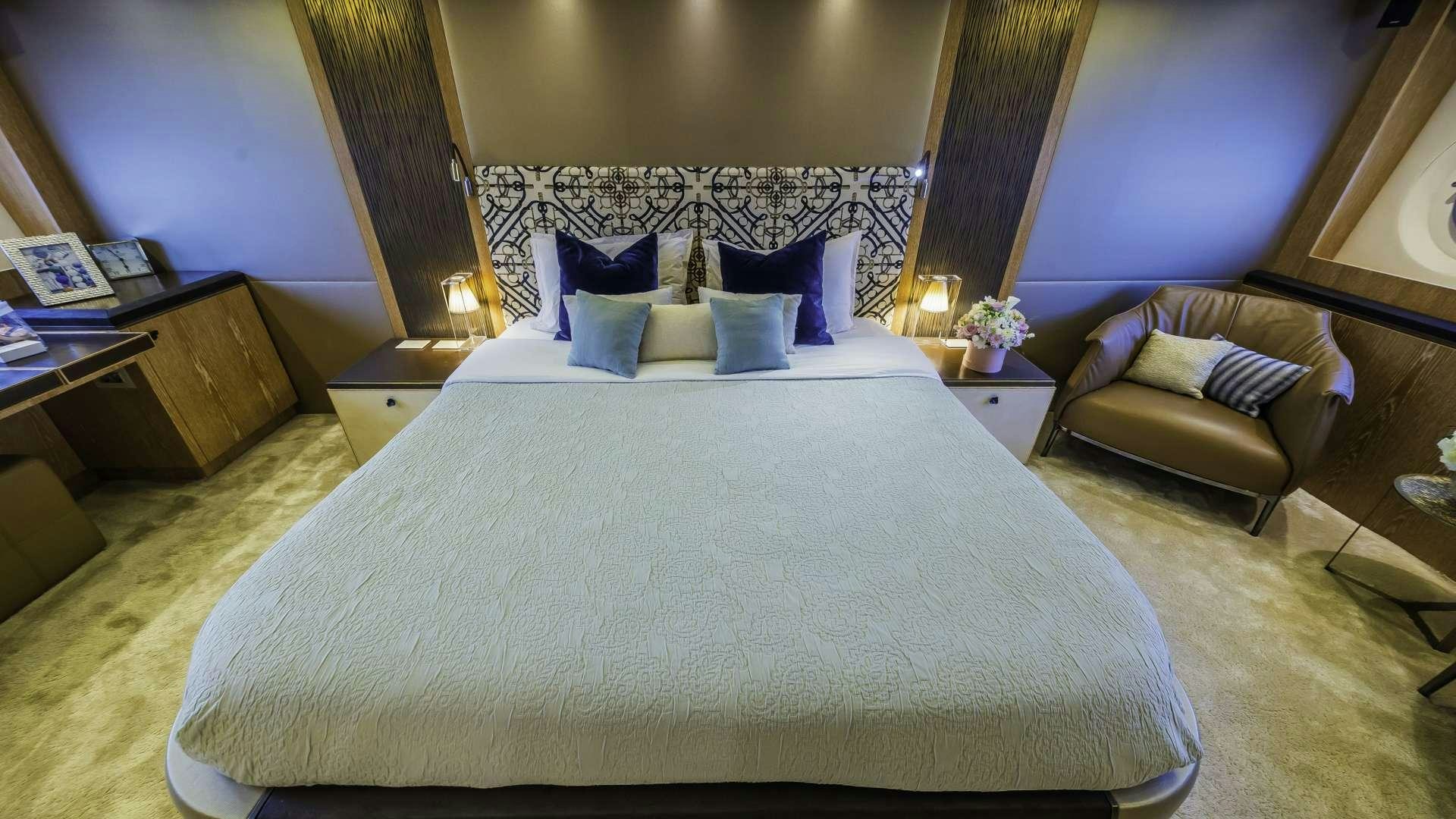 a bed with a white sheet and pillows in a hotel room aboard GIORGIO Yacht for Charter