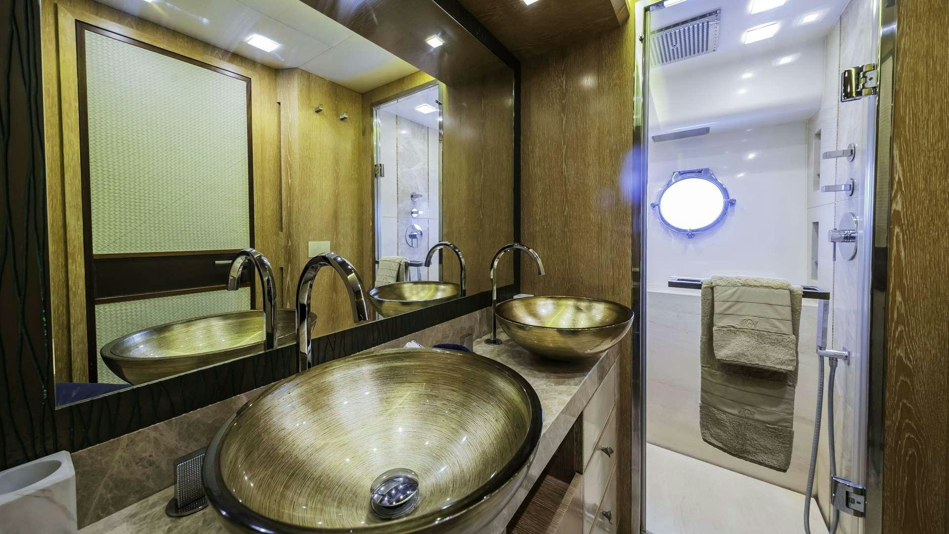 a bathroom with a sink and a mirror aboard GIORGIO Yacht for Charter