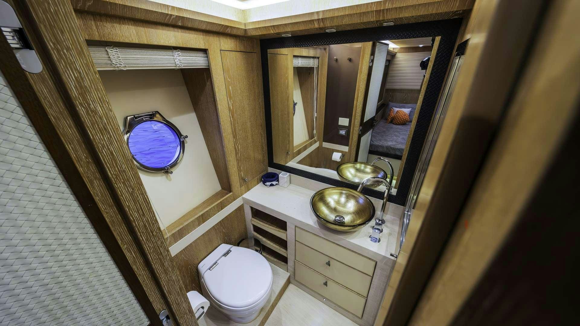 a bathroom with a round mirror aboard GIORGIO Yacht for Charter