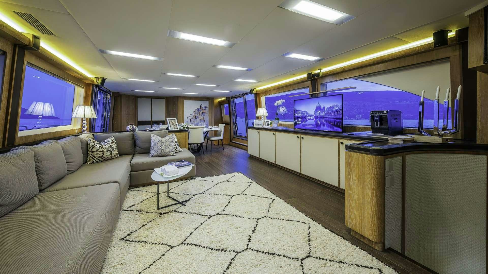 a living room with a large screen aboard GIORGIO Yacht for Charter