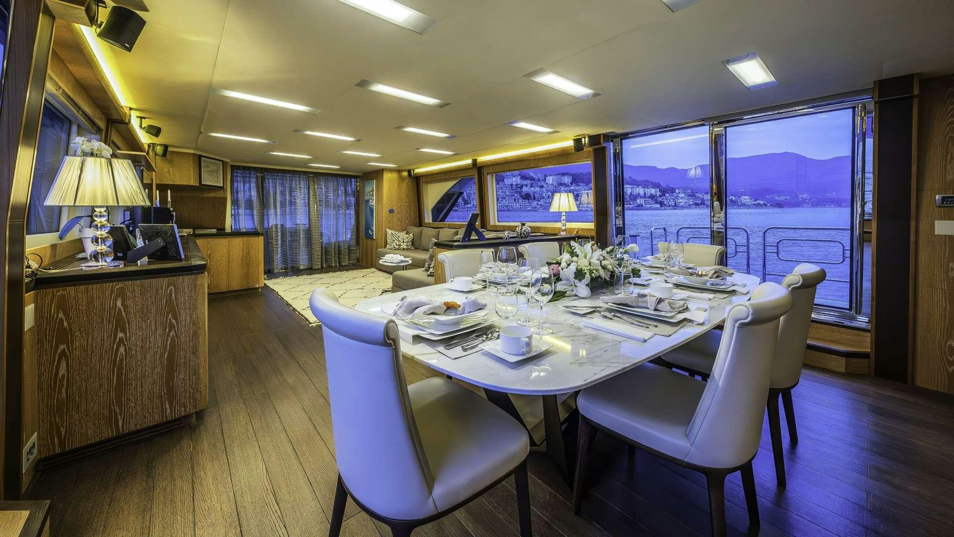 a large dining table with chairs aboard GIORGIO Yacht for Charter