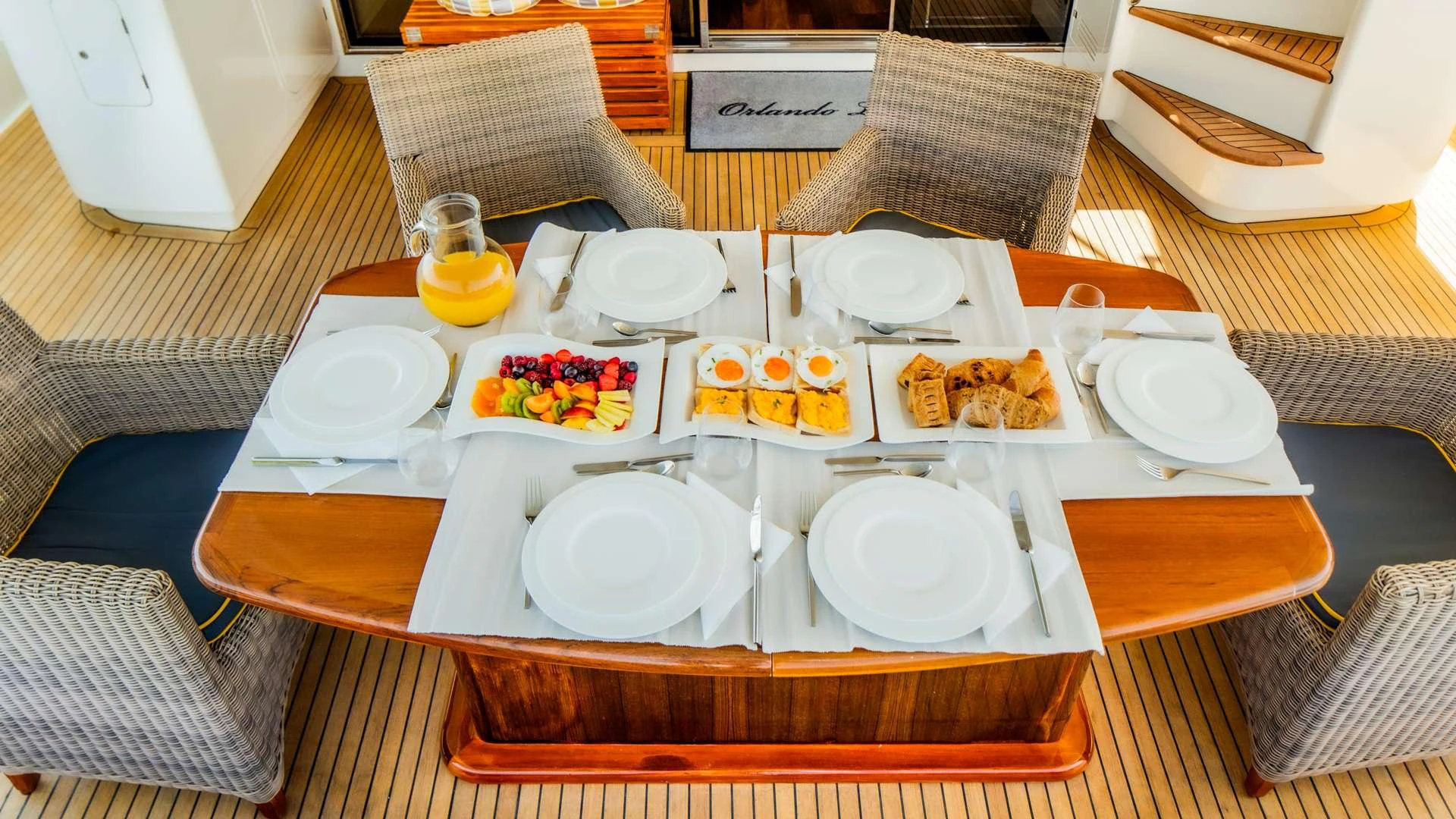 a table with plates and food on it aboard ORLANDO L Yacht for Charter