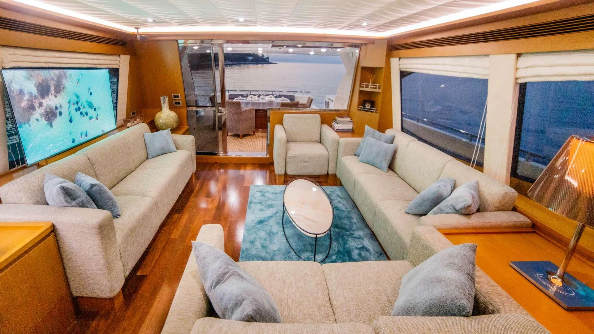 a living room with a large screen aboard ORLANDO L Yacht for Charter