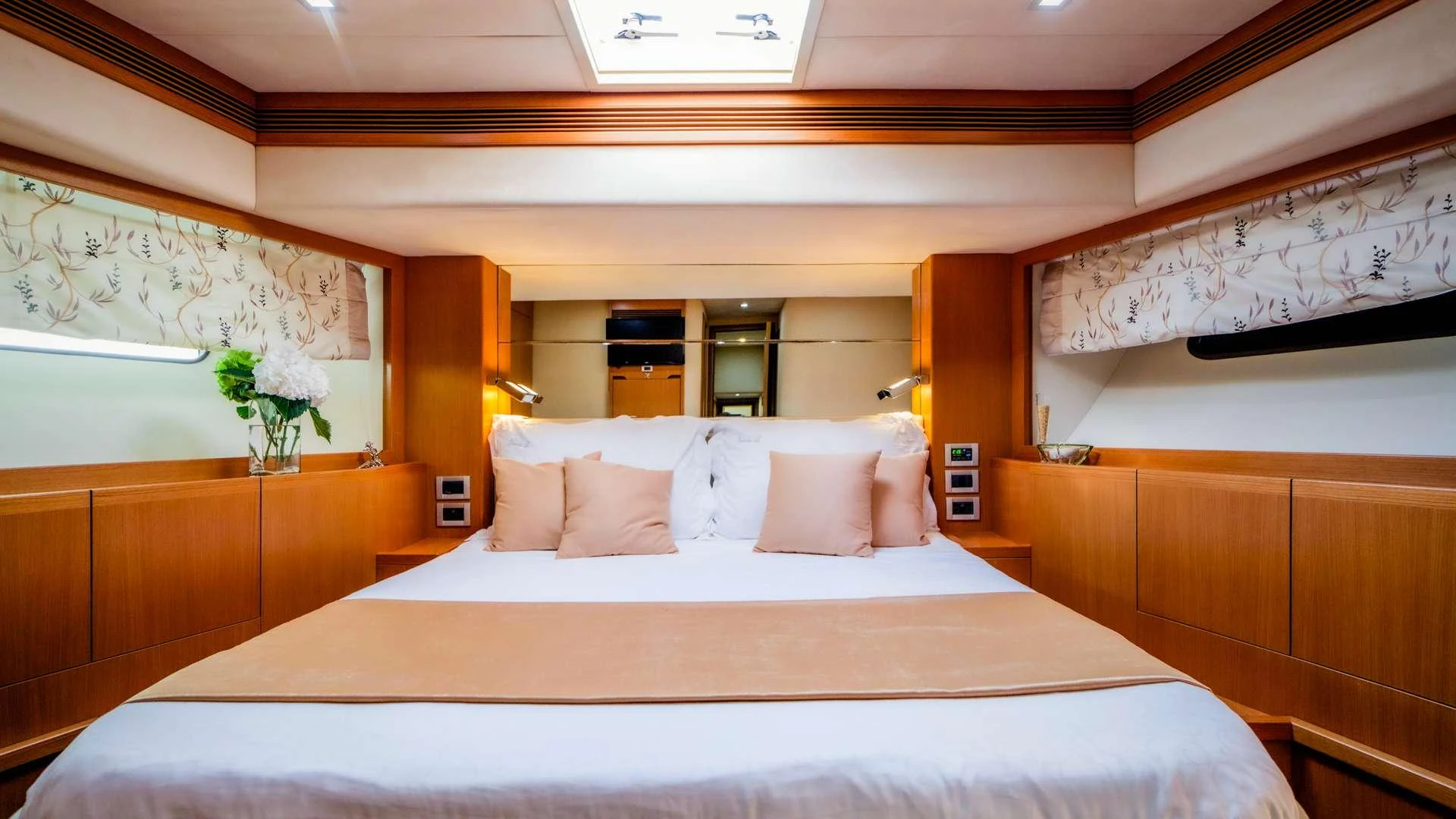 a bed with white sheets and pillows aboard ORLANDO L Yacht for Charter
