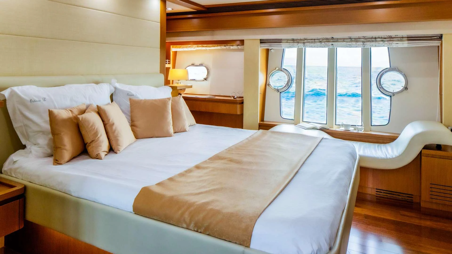 a bed with a white sheet and pillows aboard ORLANDO L Yacht for Charter