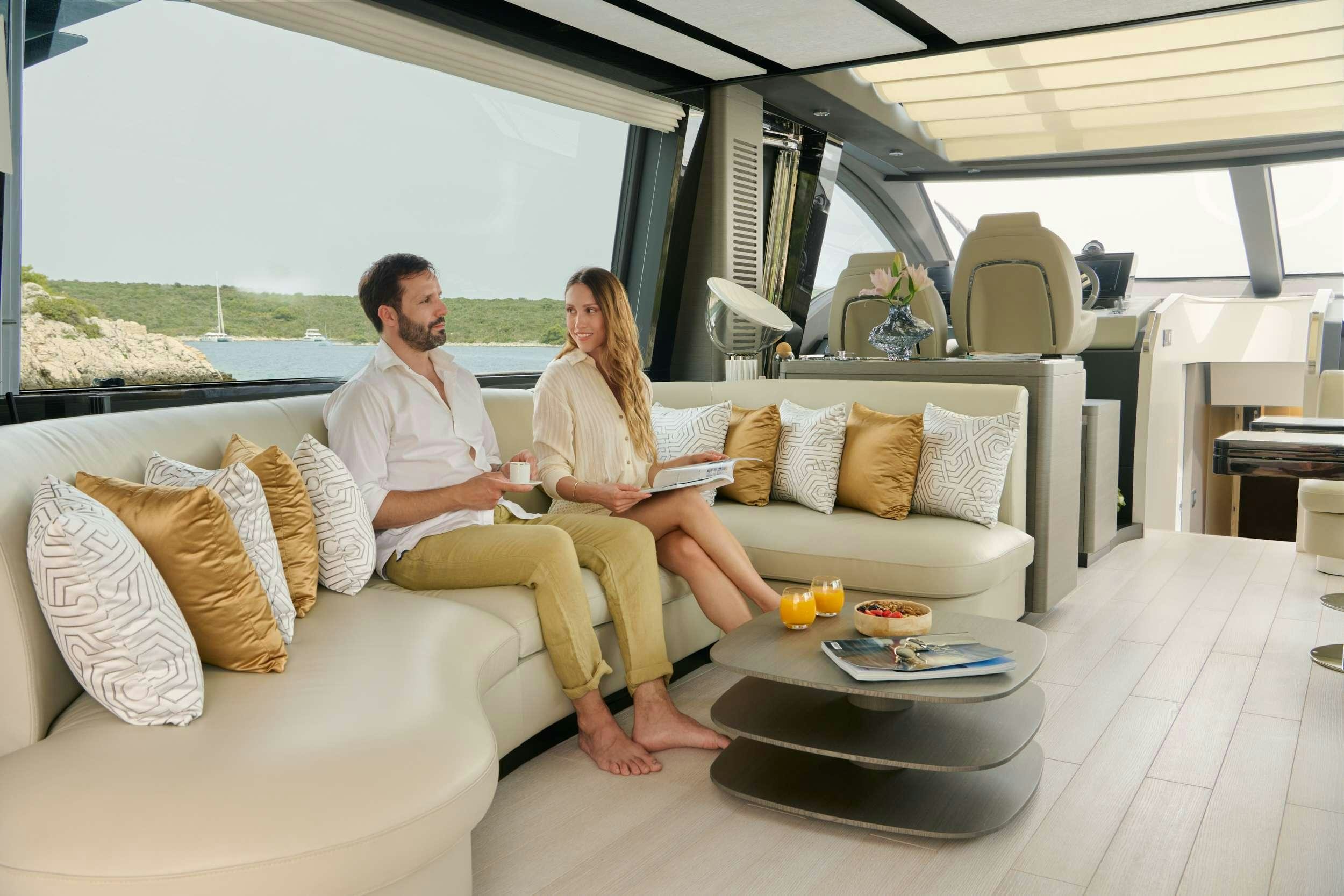 a couple sitting on a couch aboard MYNE Yacht for Charter